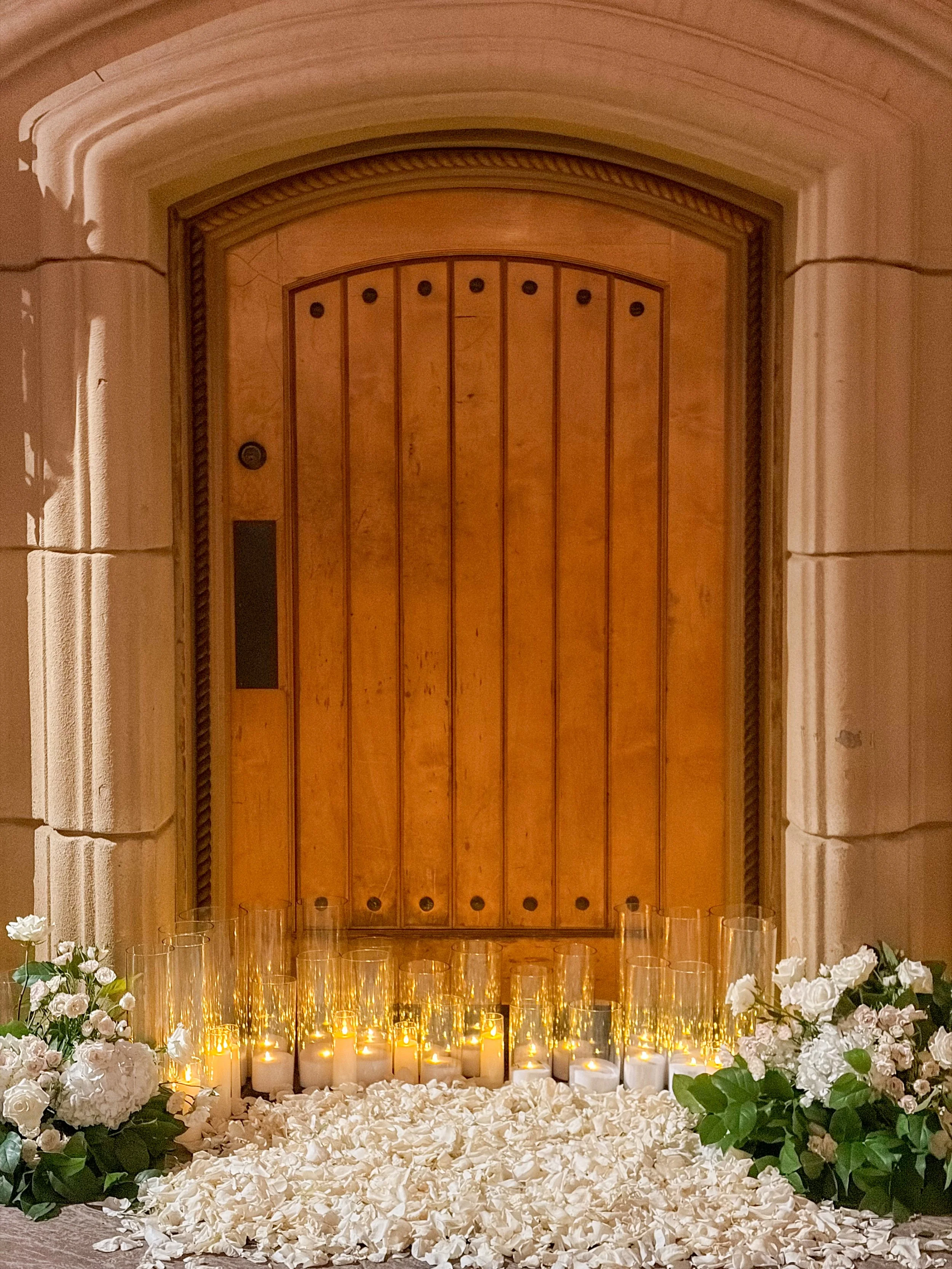Candle light and floral proposal in front of a door 