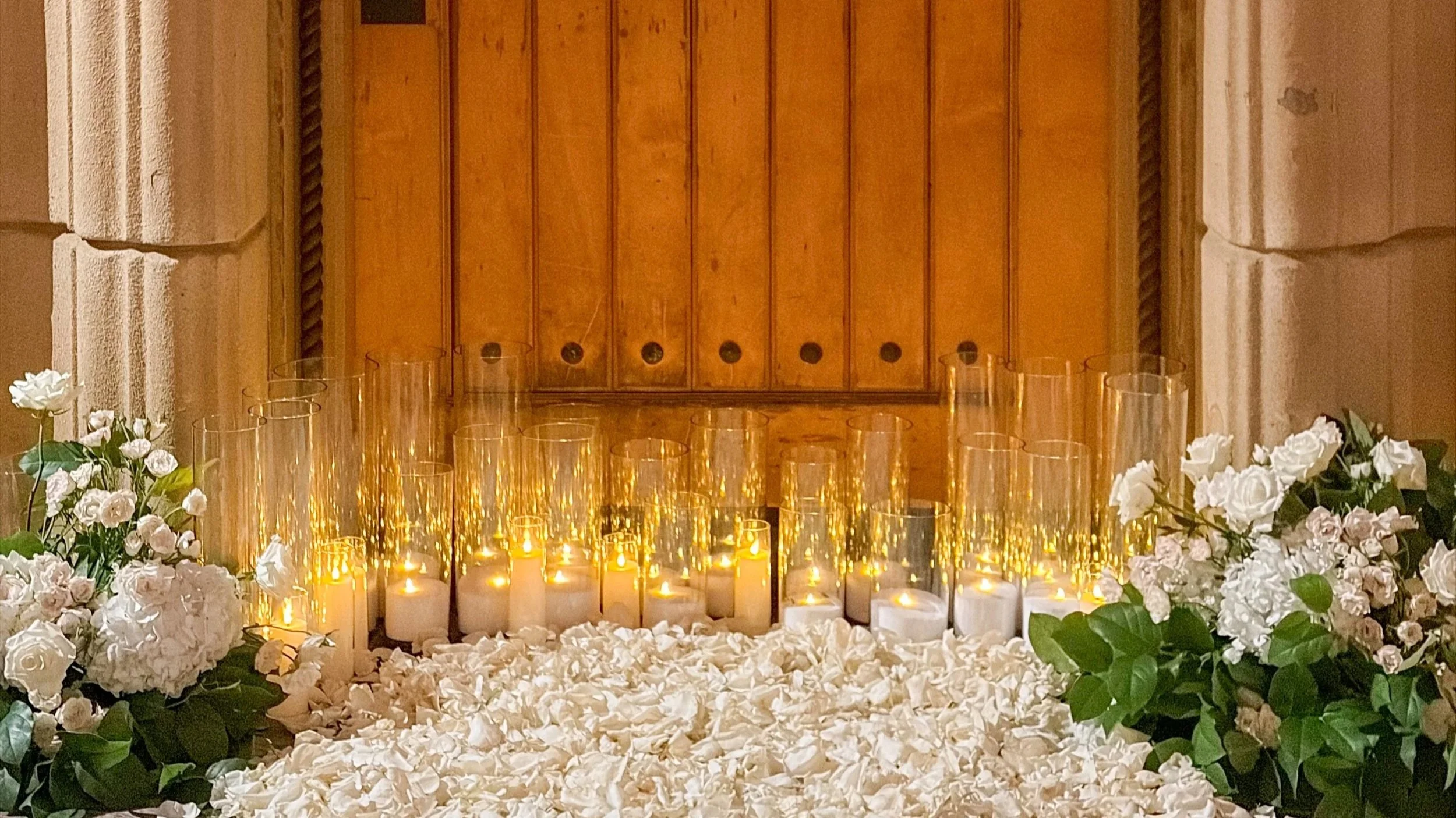 Candle light and floral proposal in front of a door 