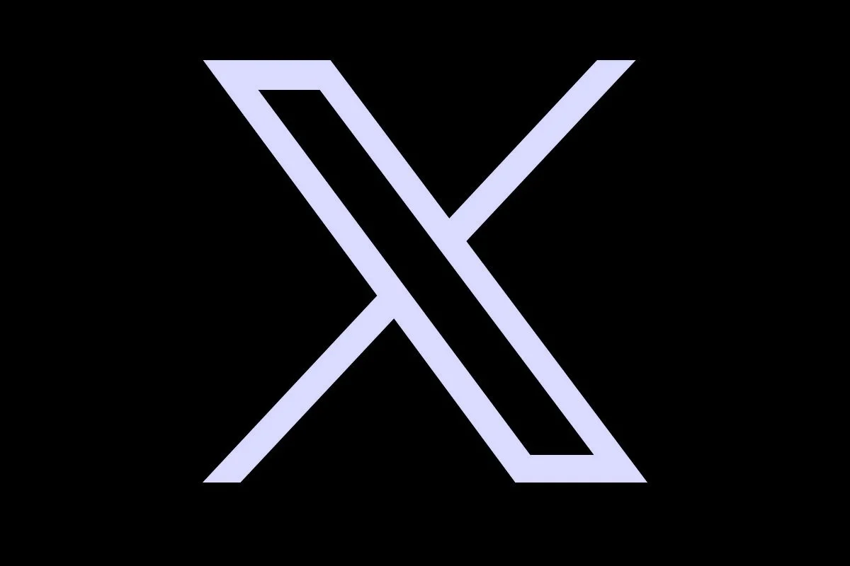 A stylized letter X with diagonal lines crossing each other on a black background.