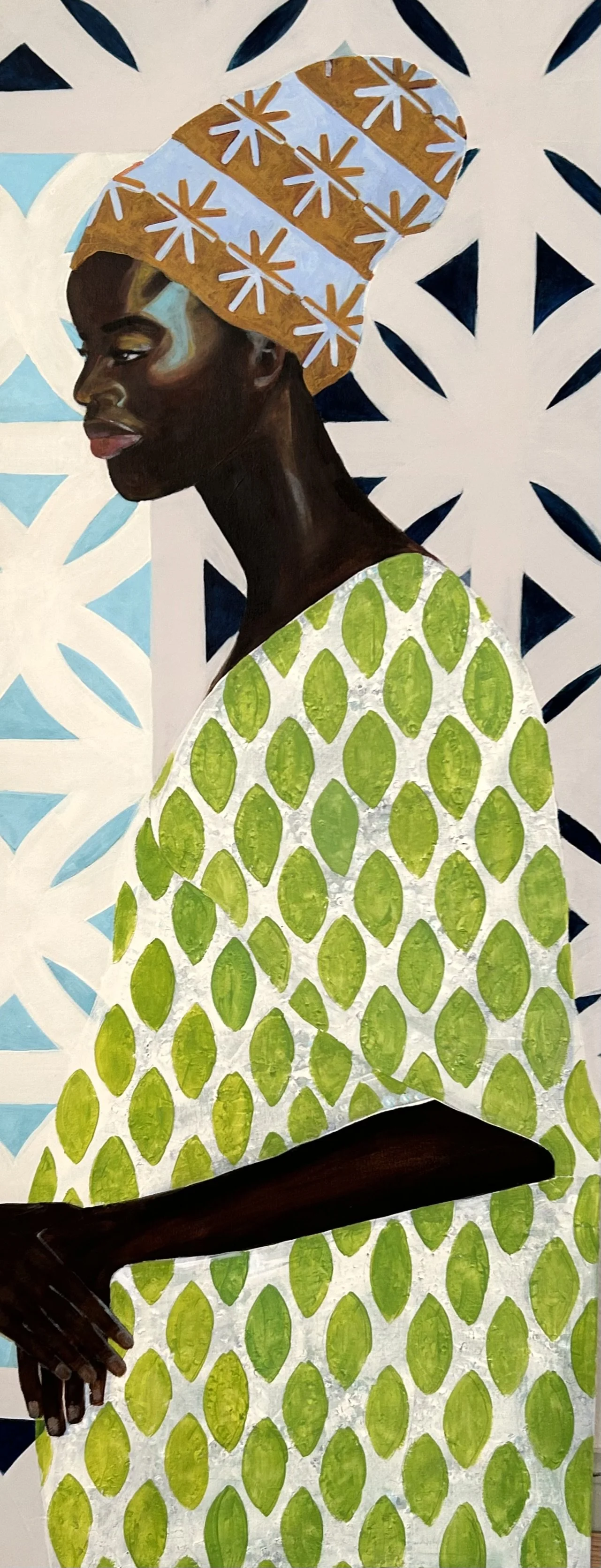 Painting of a Black woman in profile, wearing a yellow and white patterned headwrap and a green and white patterned dress, against a geometric background.
