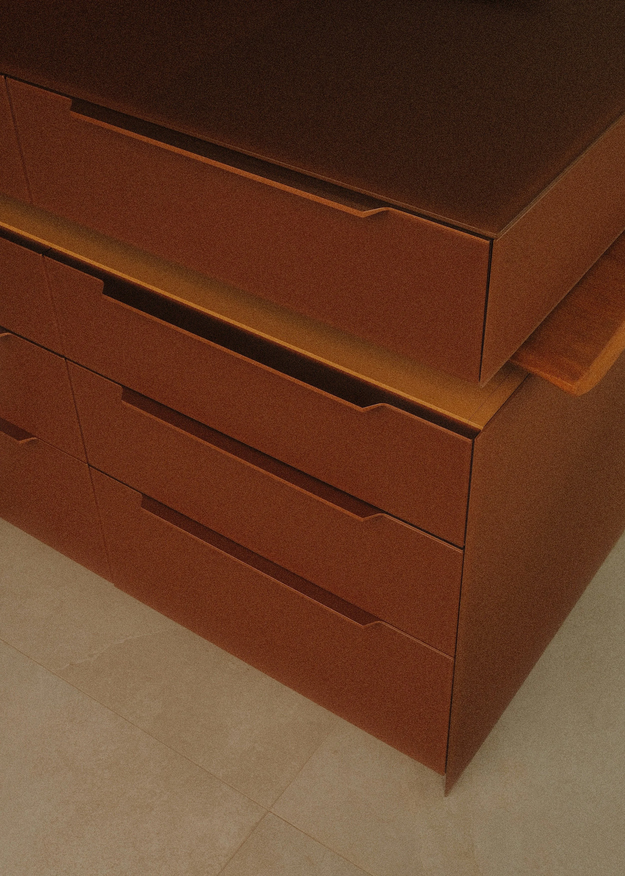 Wooden dresser with multiple drawers against a tiled floor and wall, wardrobe edit.