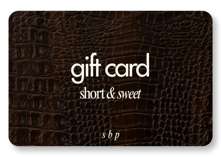 A gift card with a dark brown crocodile skin pattern, displaying the text 'gift card short & sweet' in white and light-colored fonts.