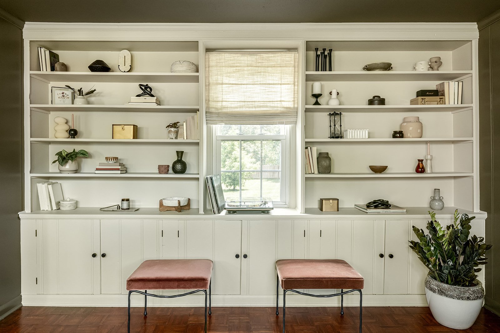 White custom built-in bookshelves styled with books and decorative objects.
