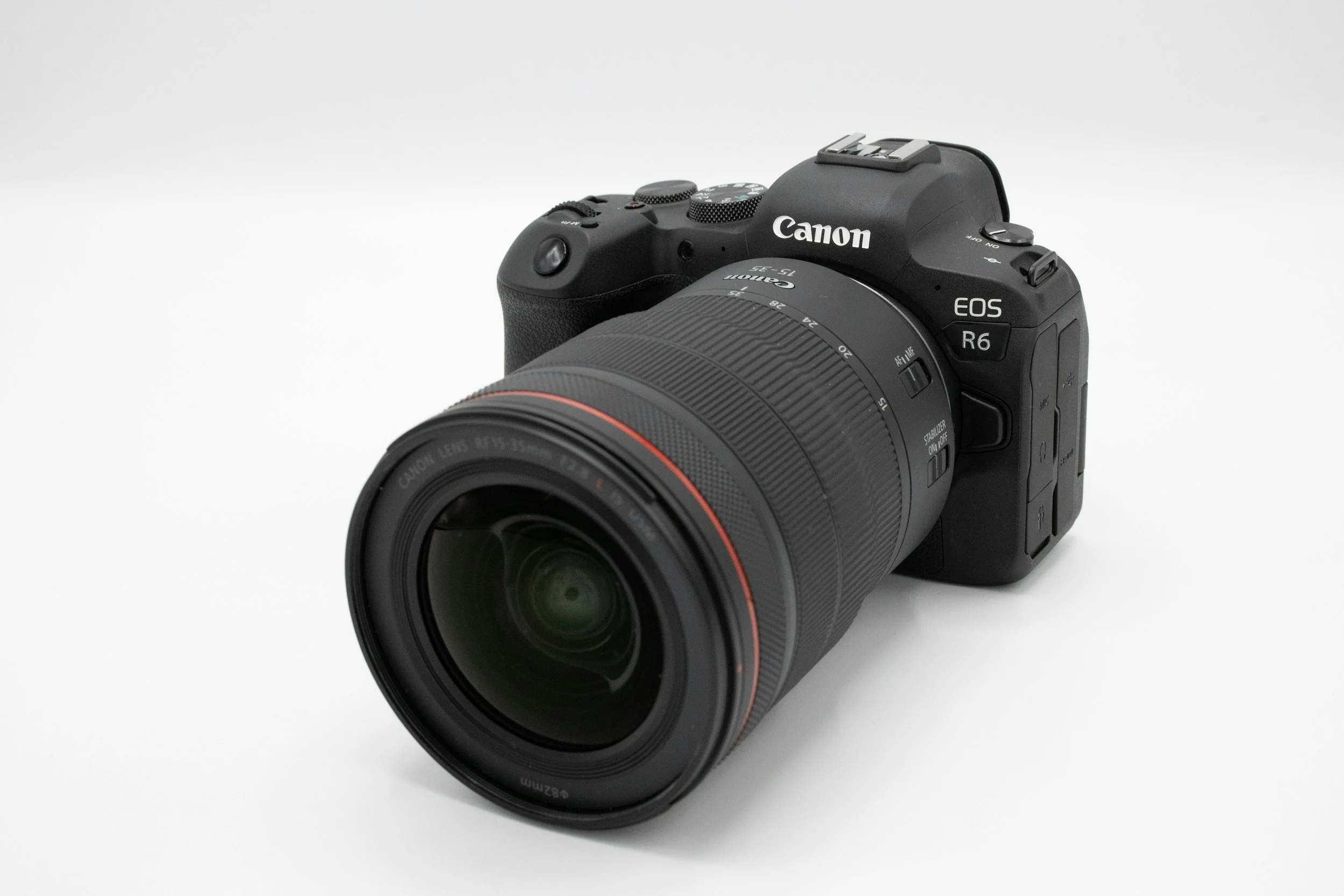 Canon EOS R6 camera with a large telephoto lens on a white background.