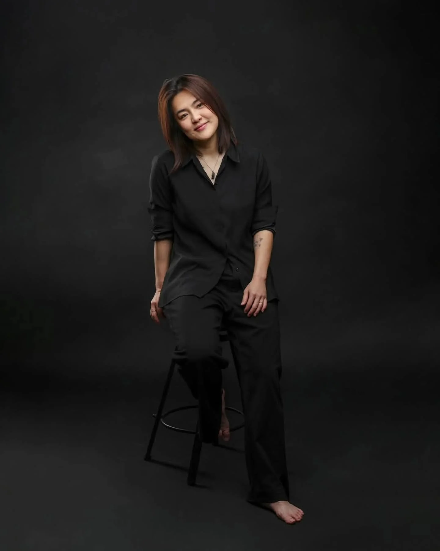 How can I ask my clients to be free and comfortable in front of the camera if I can't do it myself?

One thing I always tell them is to get comfortable with the chair. Feel the stool. Stop thinking and just be present.

But it wouldn't be fair to ask