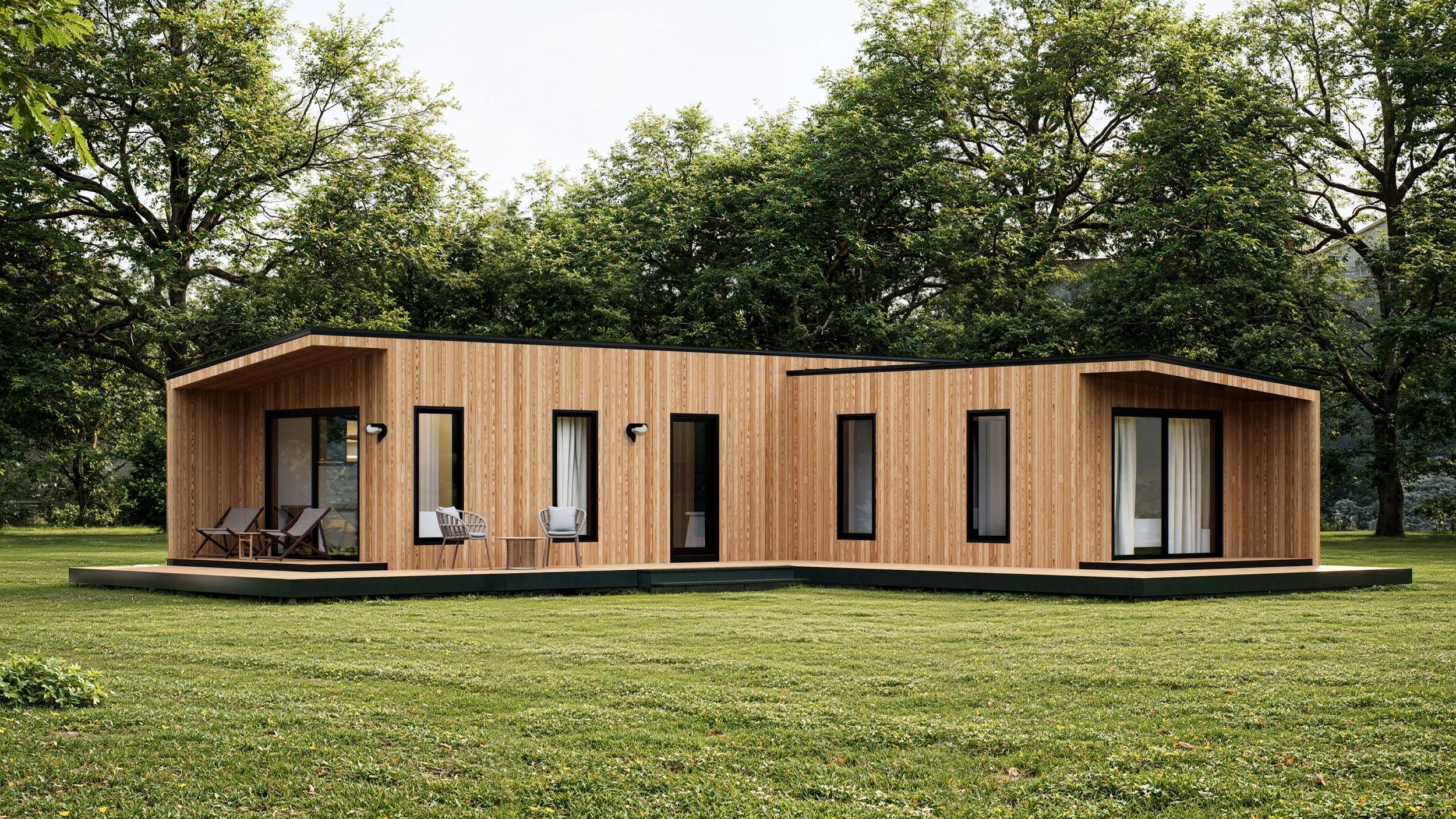 Modern wooden house with large windows and outdoor seating on a grassy lawn, trees in the background.