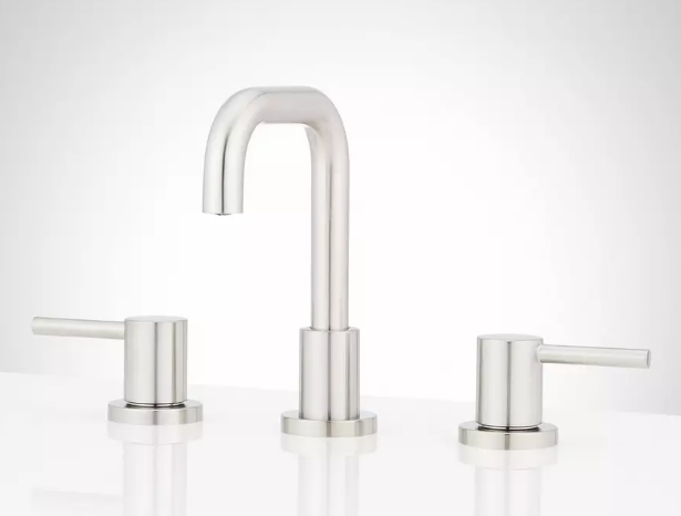 Modern silver kitchen faucet with two controls on either side, set against a plain light background.