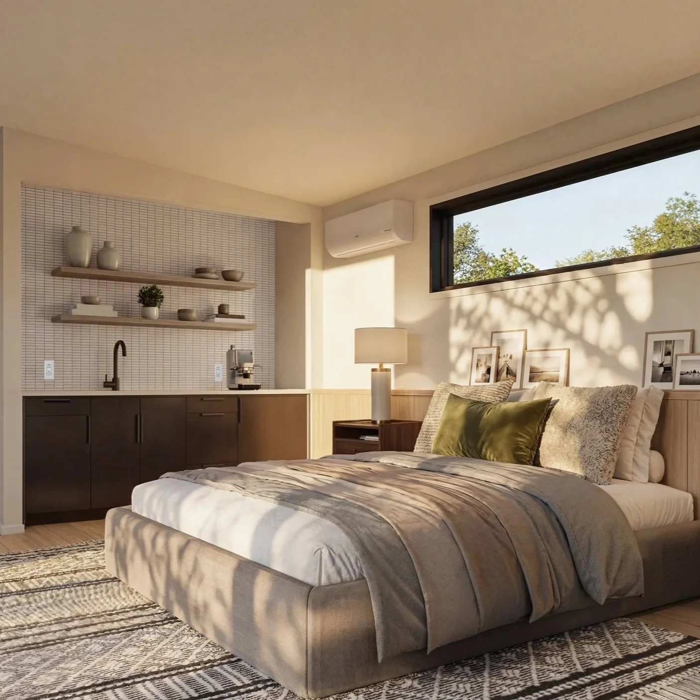 Sunlit bedroom with a bed, bedside lamp, wall shelf with decorative vases, and a kitchenette in the background with a window showing trees outside.