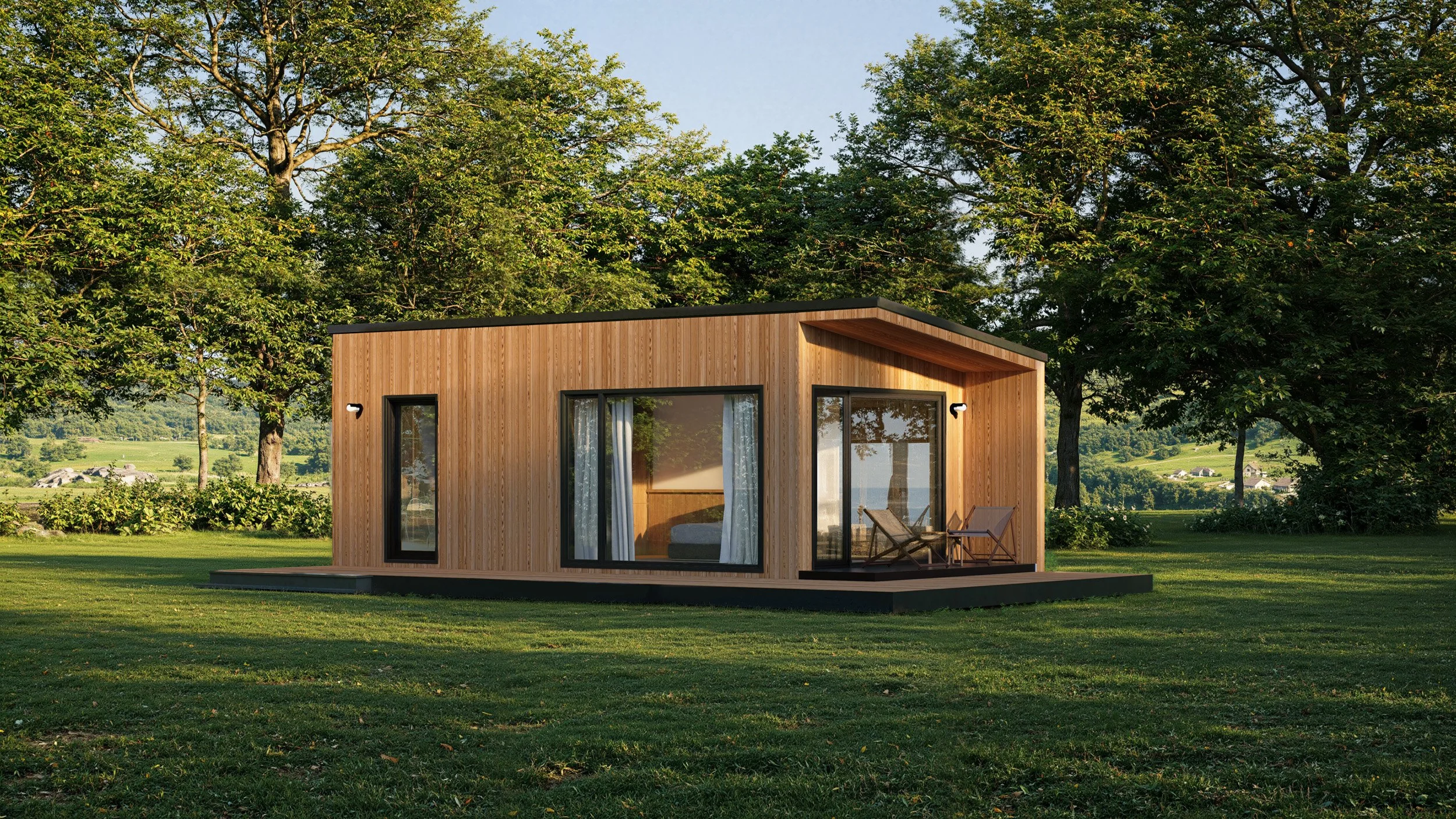A modern tiny house with wooden siding and large glass windows, situated on a grassy lawn with trees in the background.