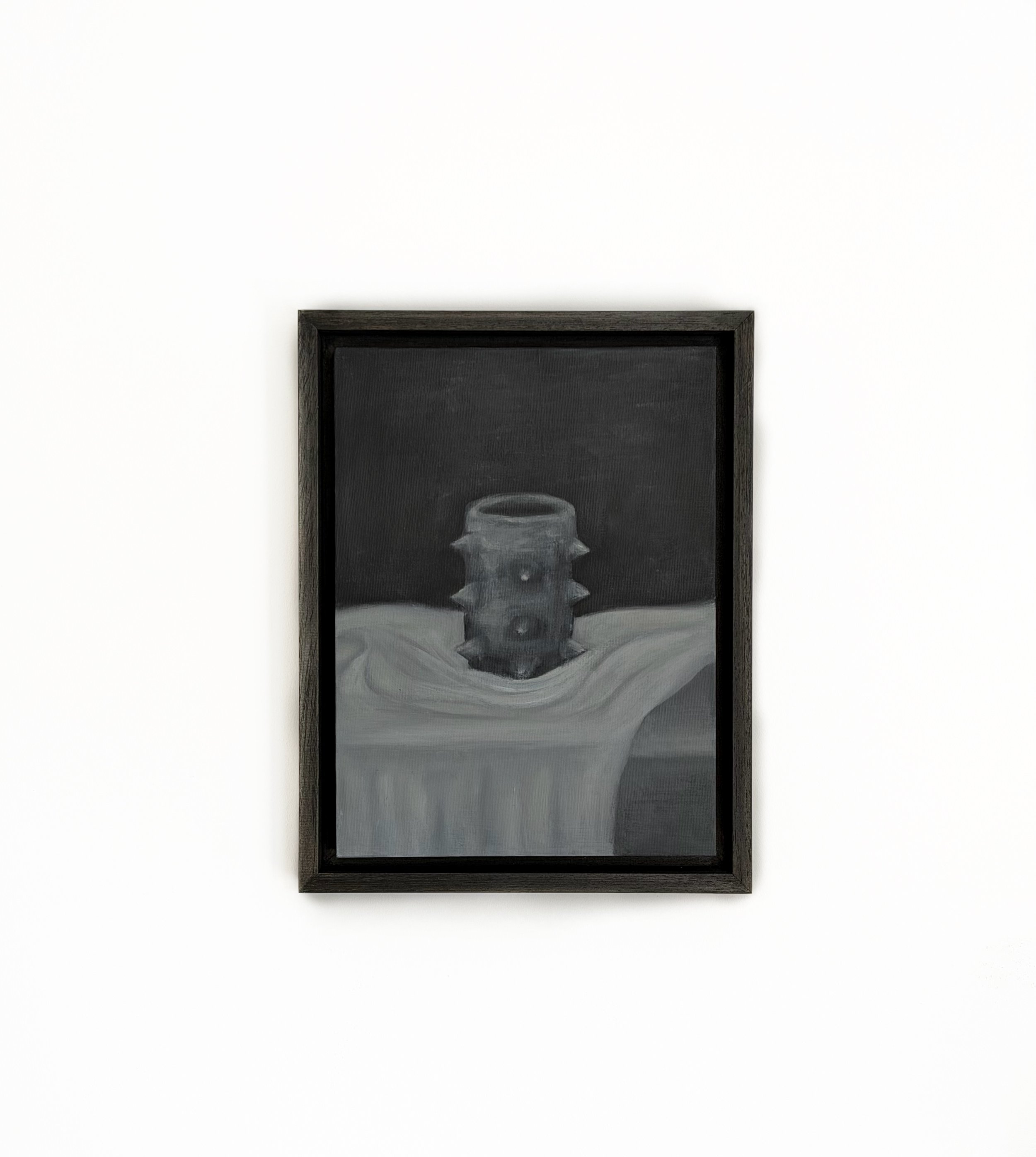 Black framed chalkboard with a drawing of a jar on a table against a white wall.