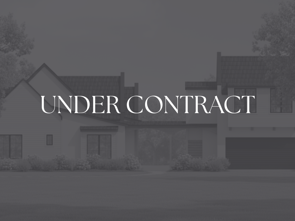 A modern two-story house with white siding and black roofing, featuring large windows, a garage, and surrounded by a green lawn and trees.