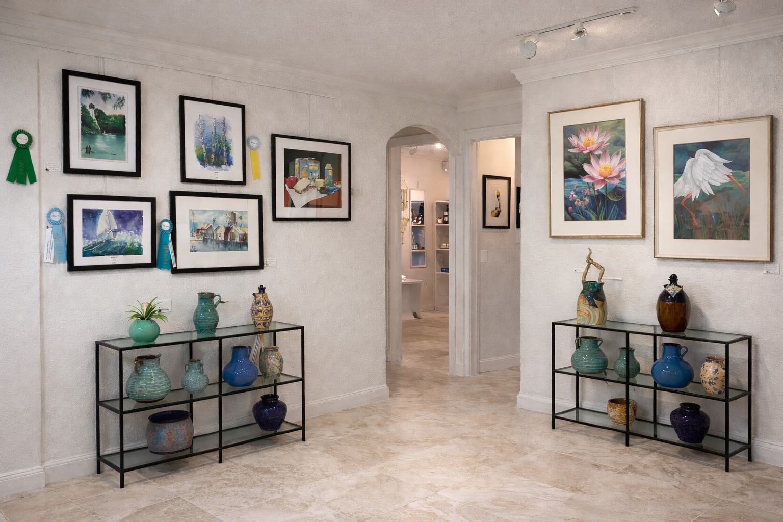 An art gallery with colorful paintings on the walls and decorative pottery displayed on two black metal shelves.