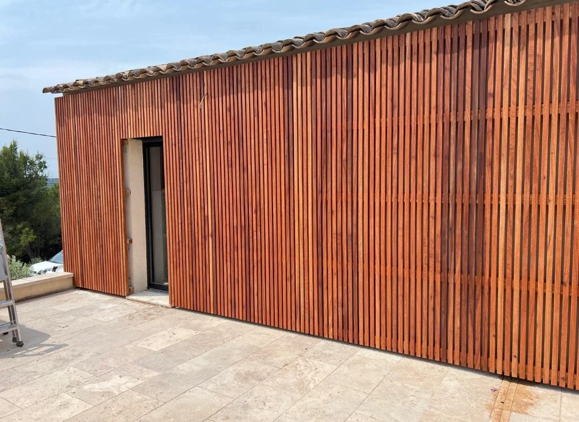 Habillage d'un mur en bois exotique.