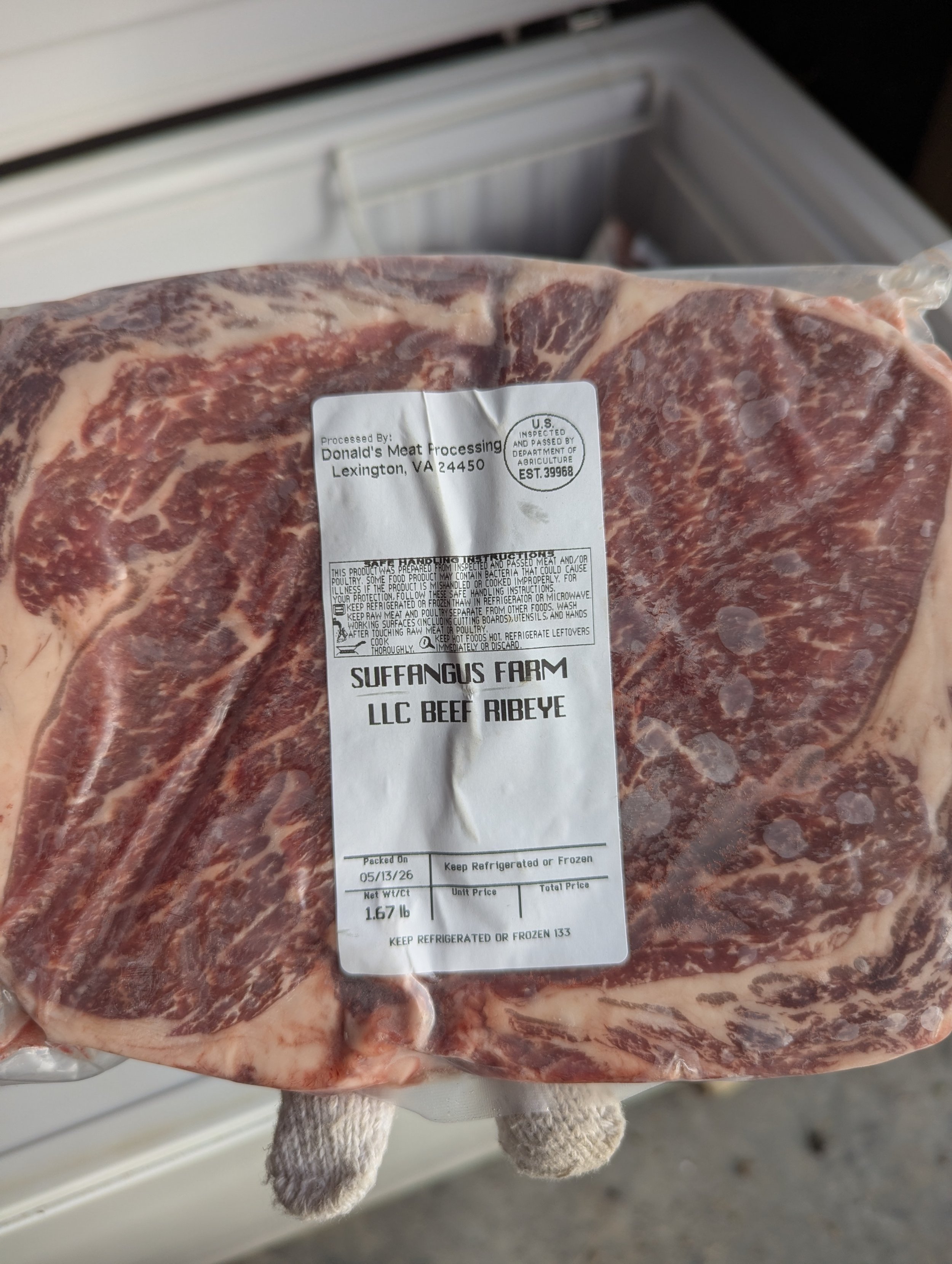 A packaged cut of beef ribeye steak from Suffolk's Farm LLC, stored in a vacuum-sealed plastic bag with a label indicating the processing date, weight, and storage instructions.