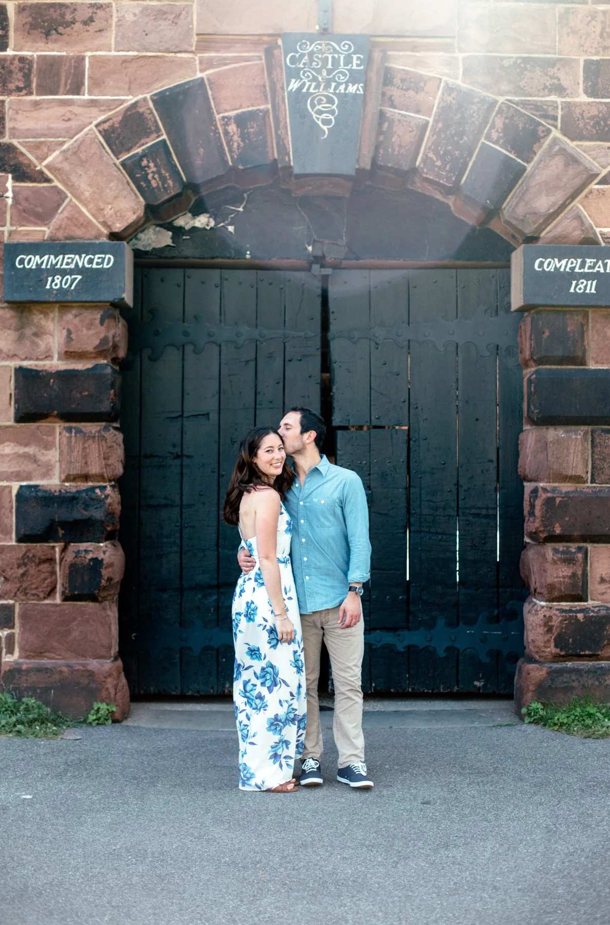 Couple posing in front of Castle Williams entrance gate.