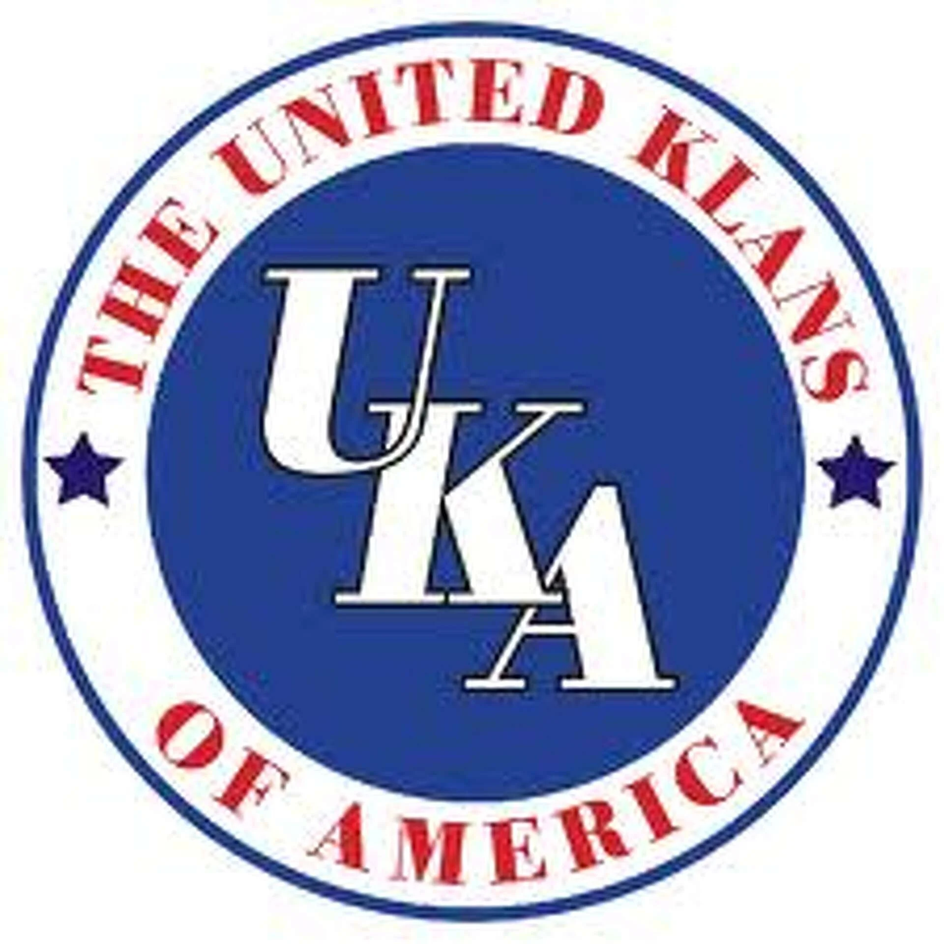 Close-up of a circular logo with a blue background and white text, partially visible, with red text around the outer edge reading ''UNITED INK'' and ''METRICS.''