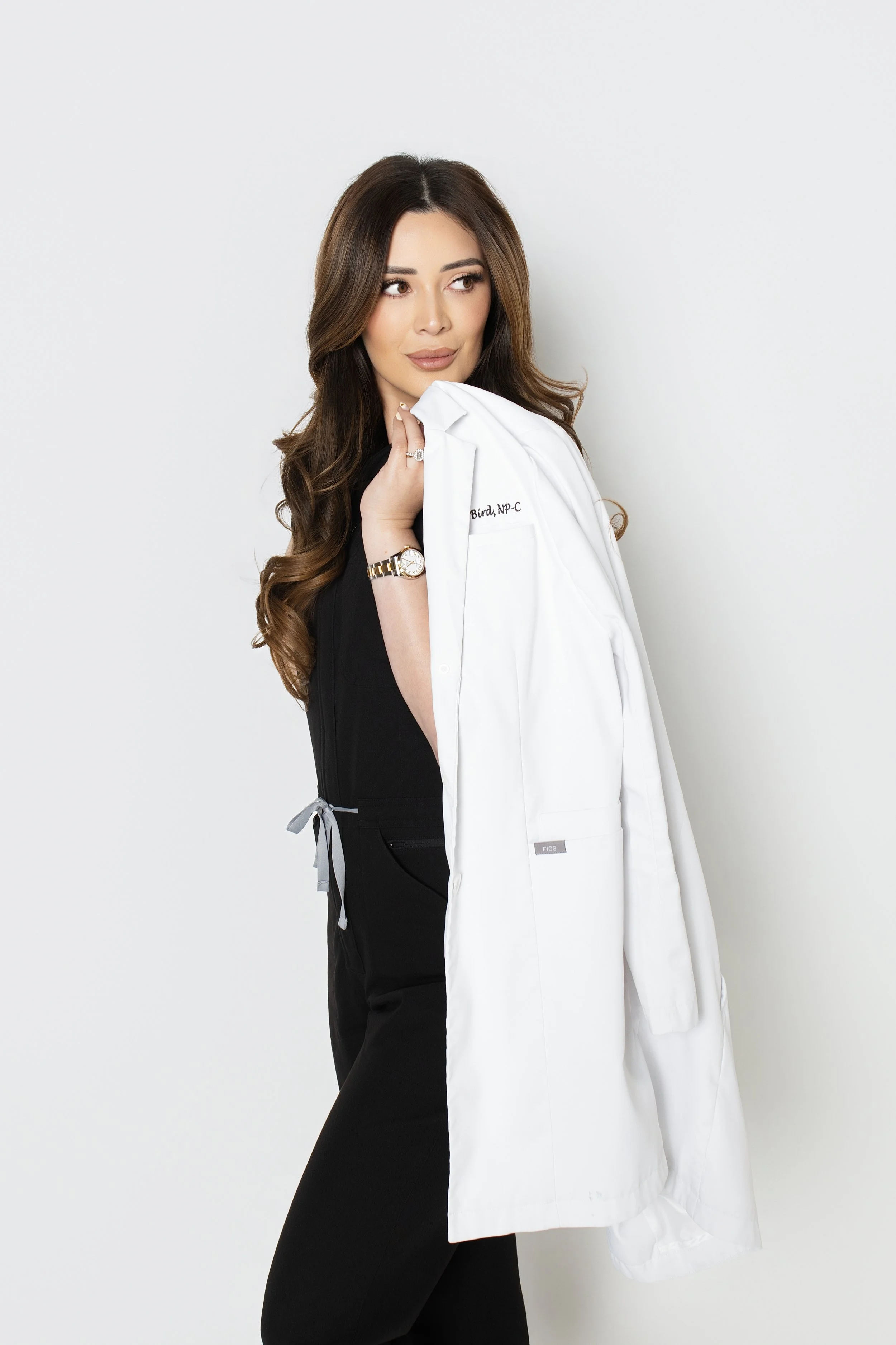 woman looking away holding white coat