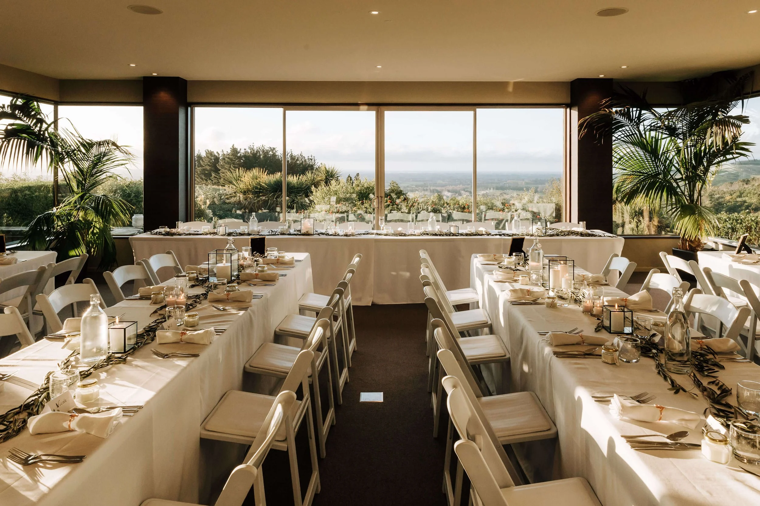 Wedding reception at Waipuna Estate with long banquet tables and panoramic Canterbury views.