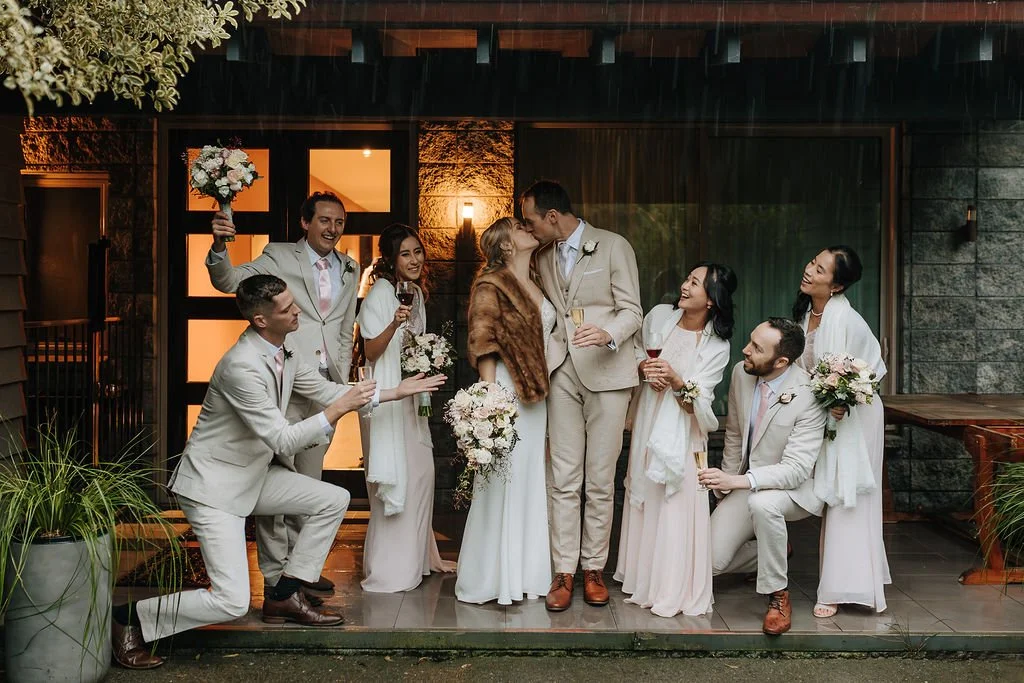 Bride and groom celebrating with their family and wedding party at Waipuna Estate