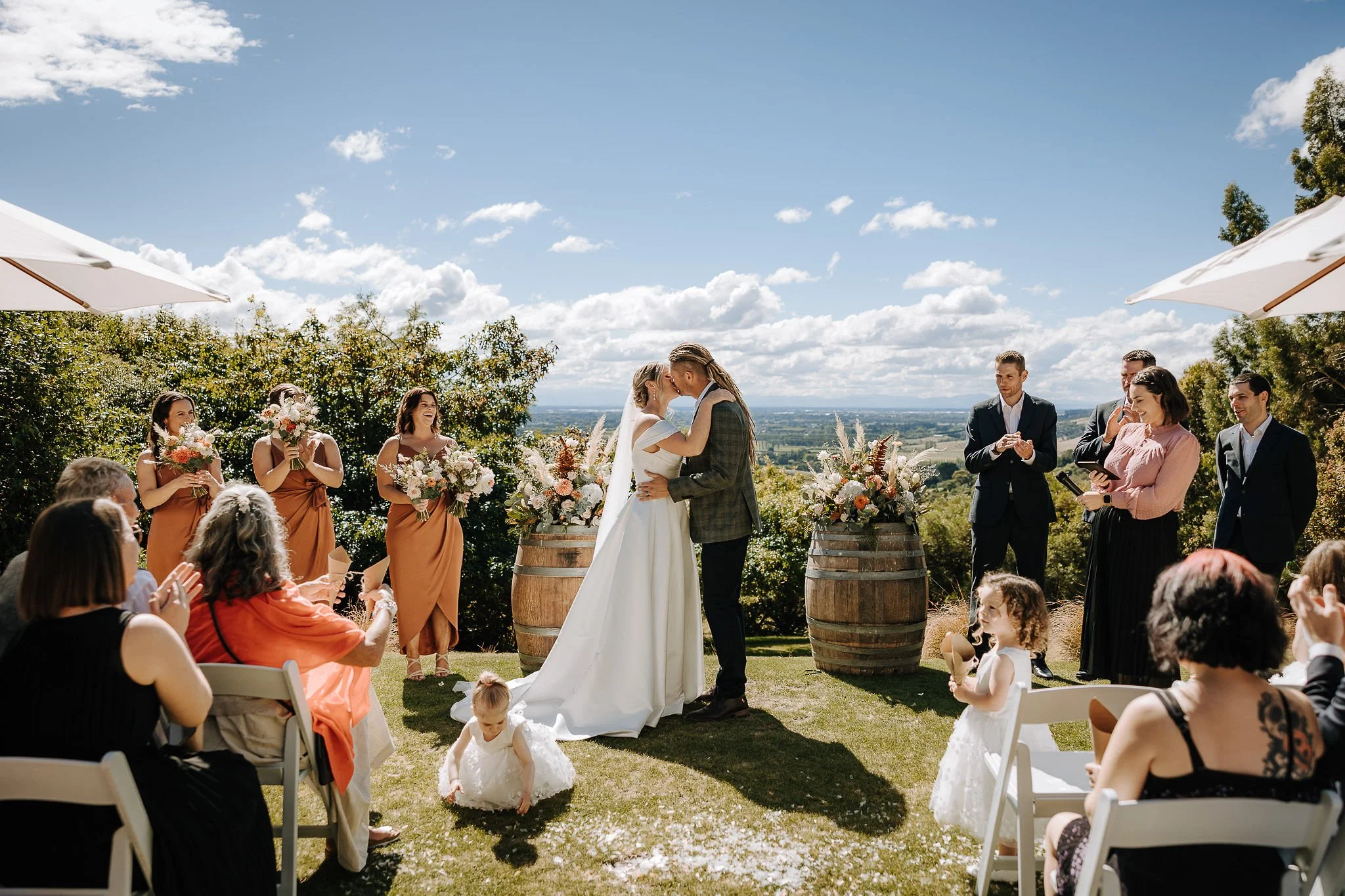 Outdoor wedding ceremony overlooking the gardens at Waipuna Estate