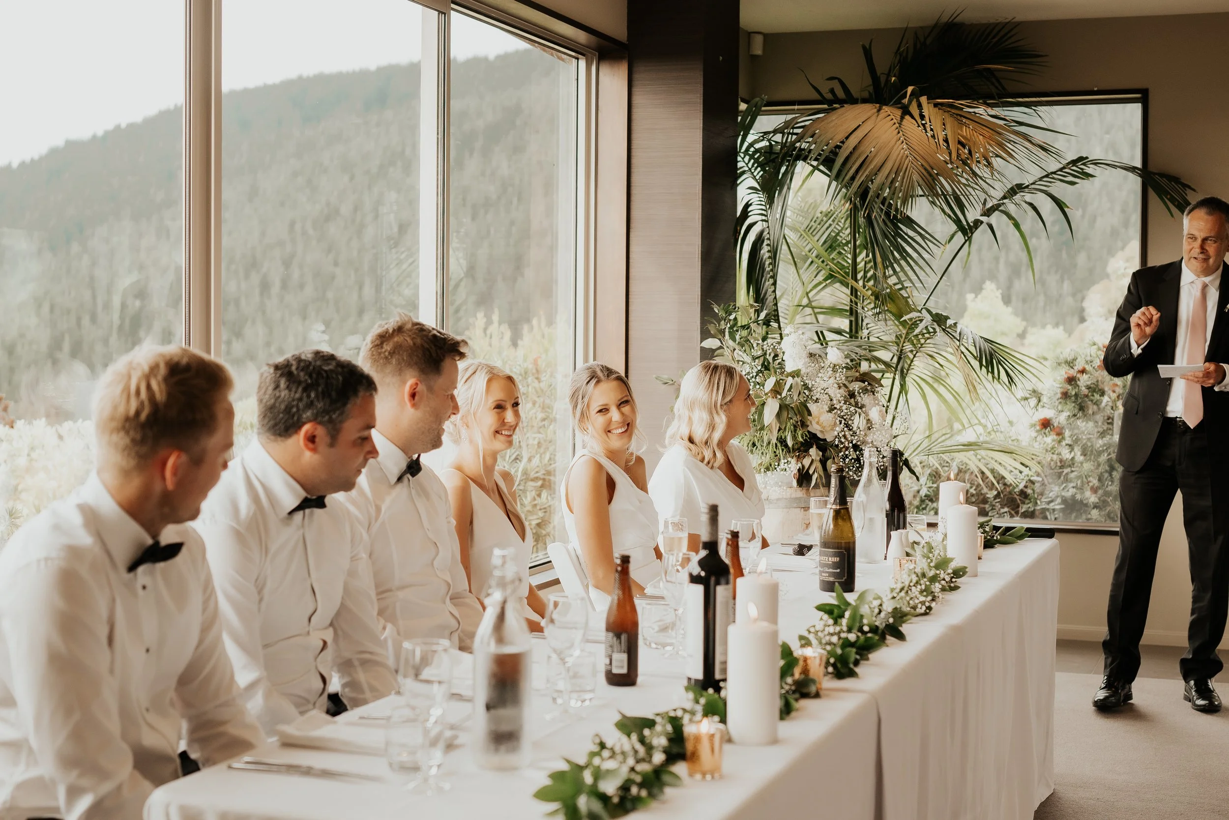 A traditional head table set for the bridal party and couple, with elegant décor at Waipuna Estate