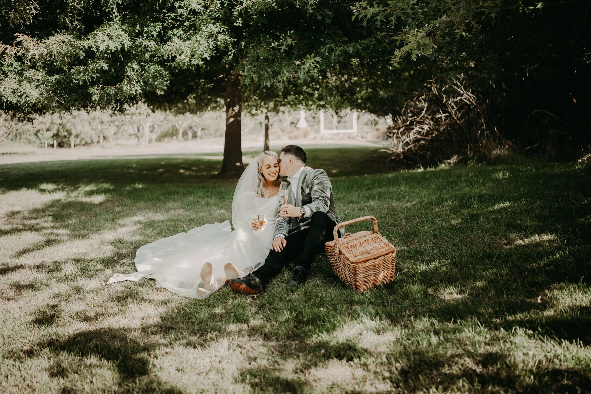 A relaxed couple enjoying their wedding day together at Waipuna Estate surrounded by natural scenery
