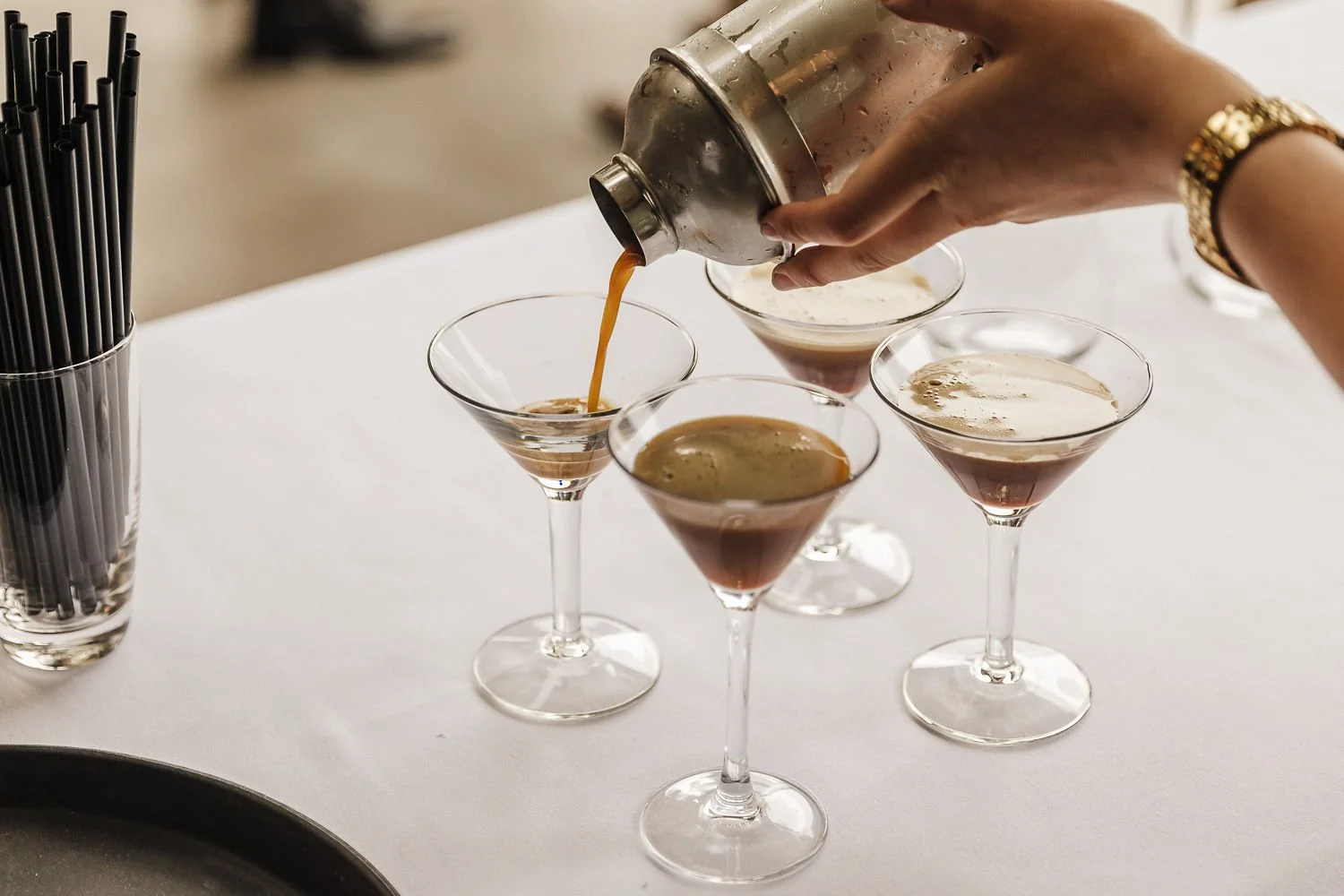 Guests enjoying a gin bar at a wedding, selecting from a range of gins and garnishes to create their perfect drink.