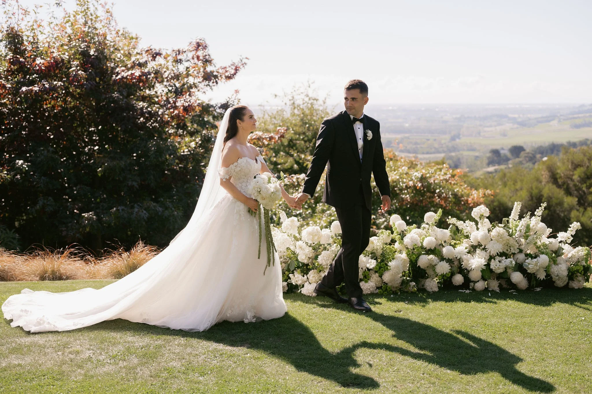 Bride and groom enjoying portraits around the natural surroundings of Waipuna Estate