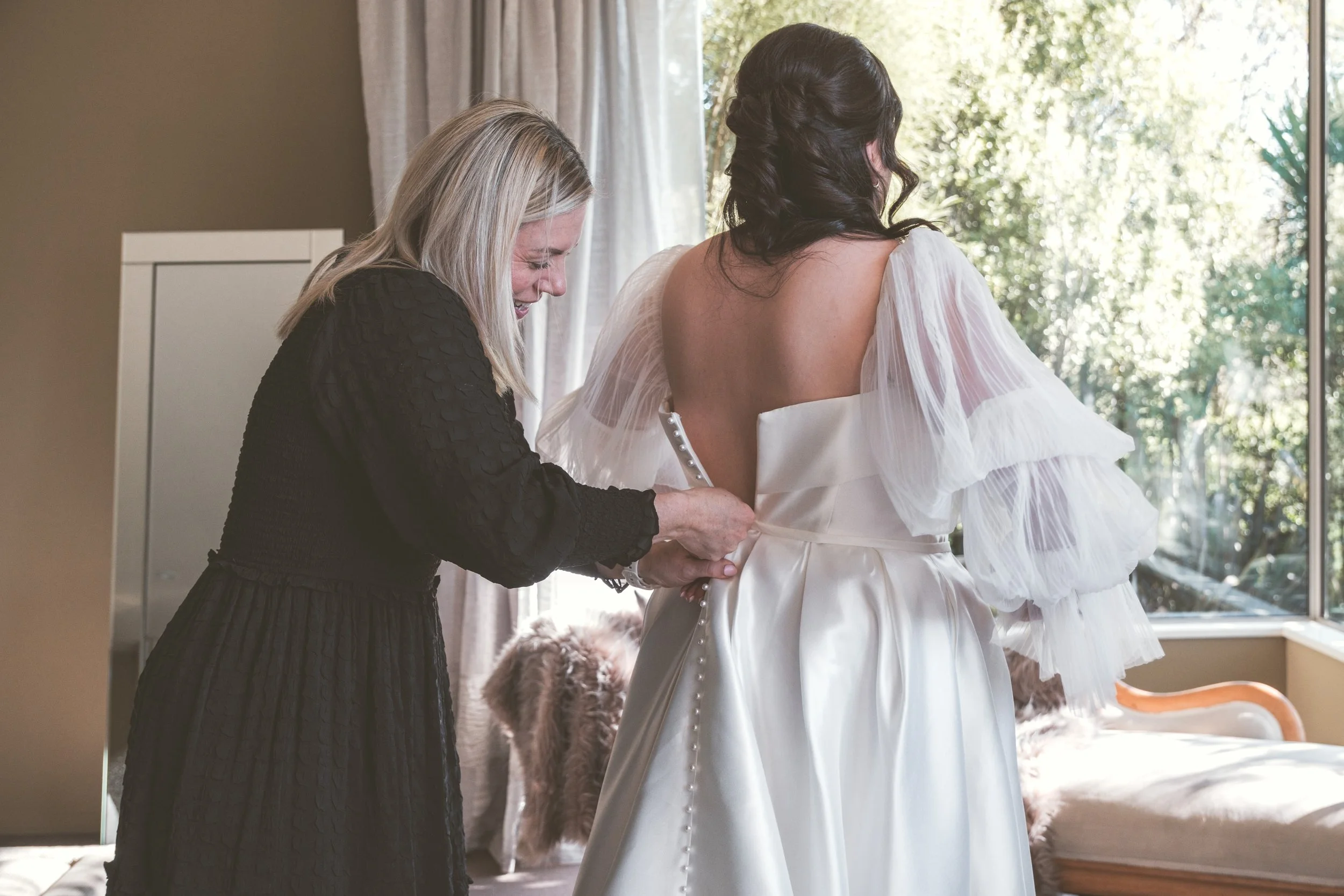 Wedding coordinator assisting a couple before their ceremony at Waipuna Estate.