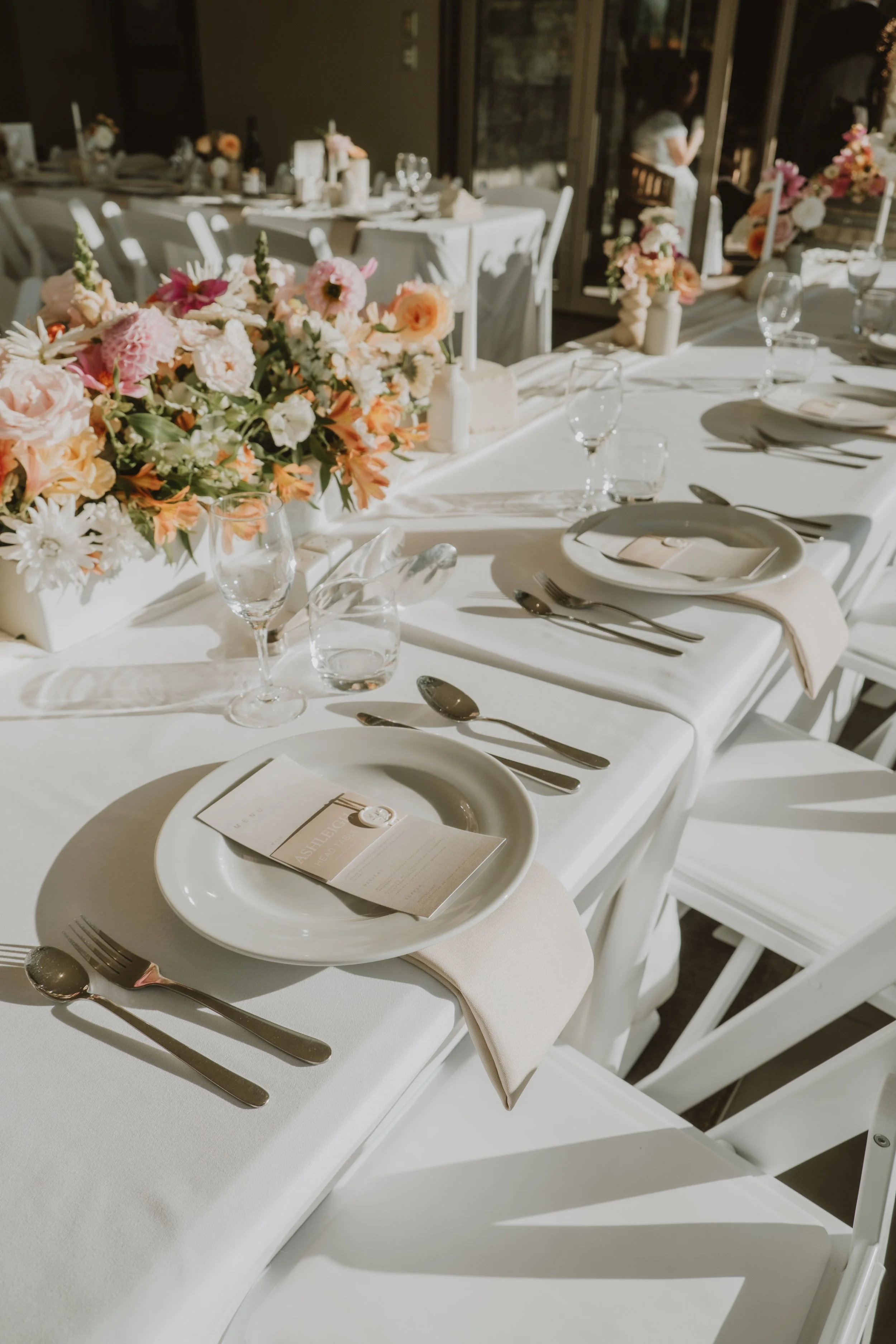 Wedding table styling with elegant place settings and catering details at Waipuna Estate