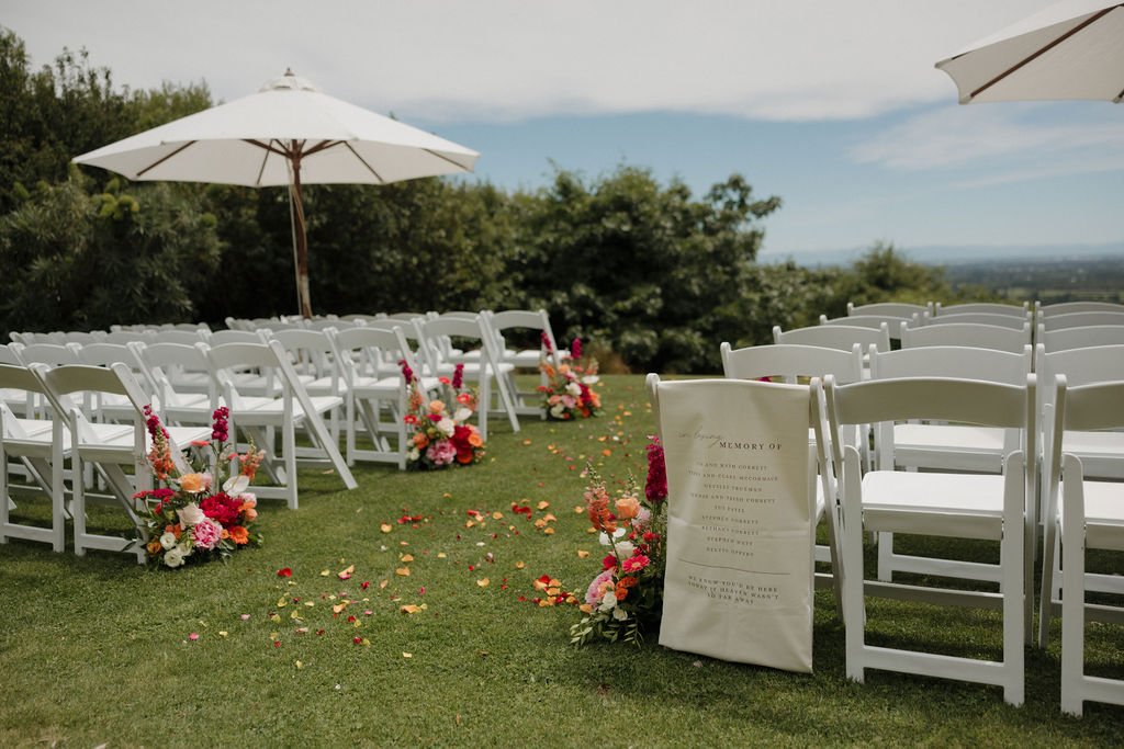 Wedding ceremony floral arrangements styled to complement the natural surroundings at Waipuna Estate
