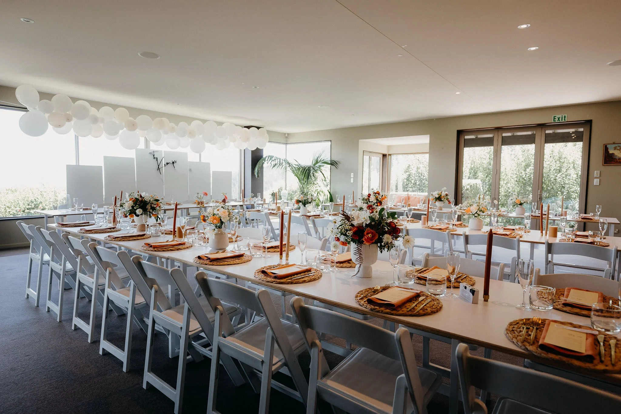 Wedding reception setup with tables and chairs at Waipuna Estate