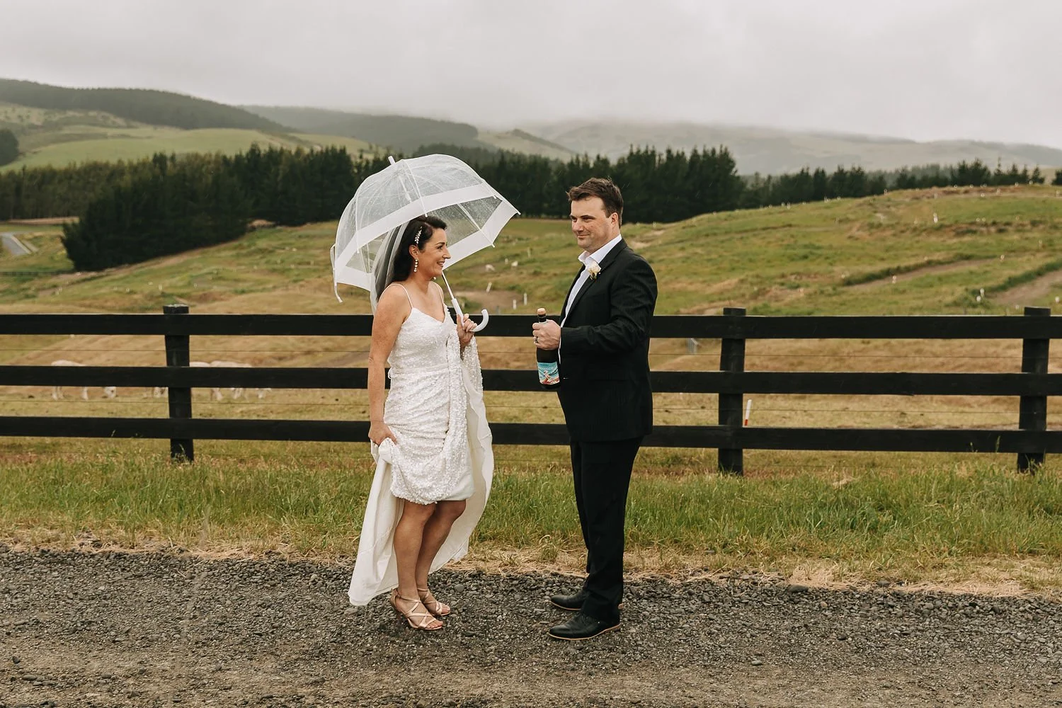 Wedding umbrella for the bride to stay dry at Waipuna Estate
