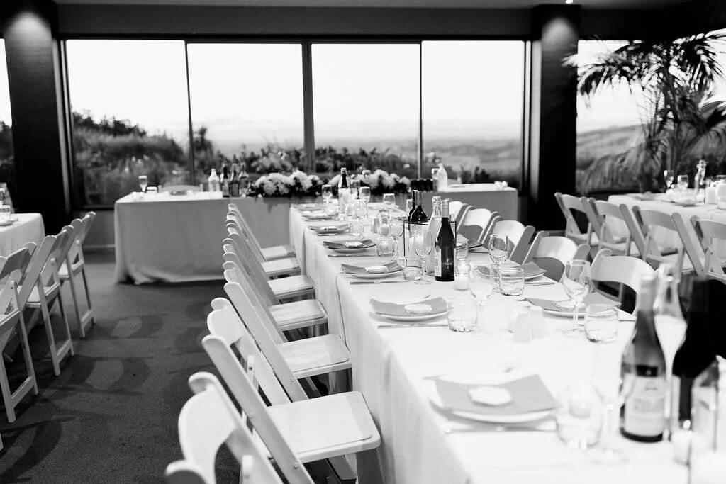Simple wedding table decor with candles and greenery at Waipuna Estate