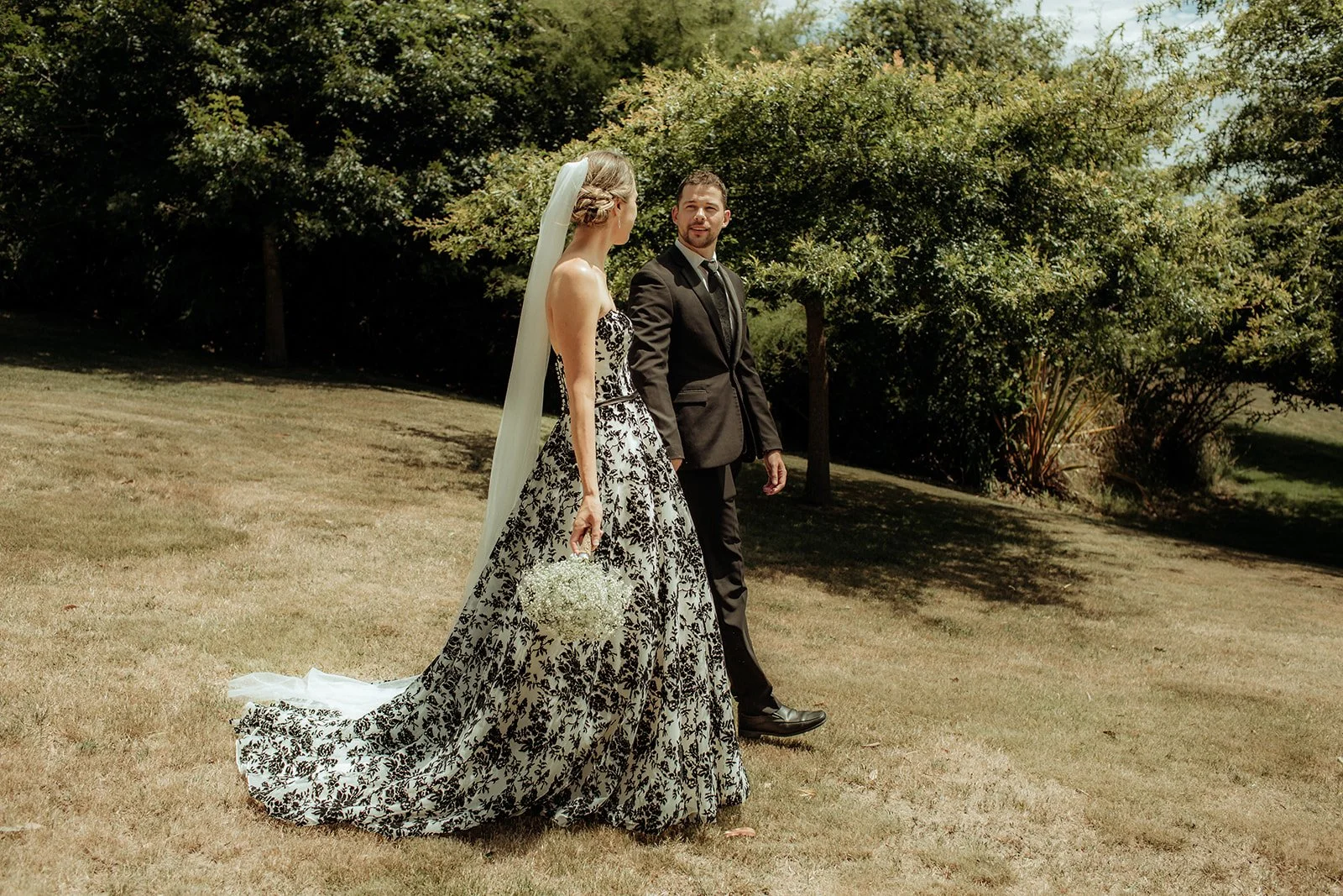 Bride wearing a chic non white wedding gown at Waipuna Estate, breaking away from traditional wedding attire