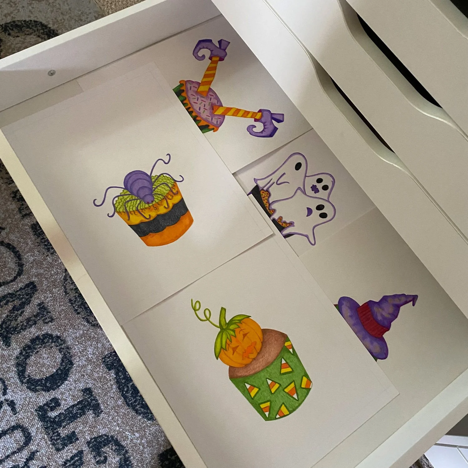 Studio, Open Drawer Showing Final Illustrations of Halloween Cupcake