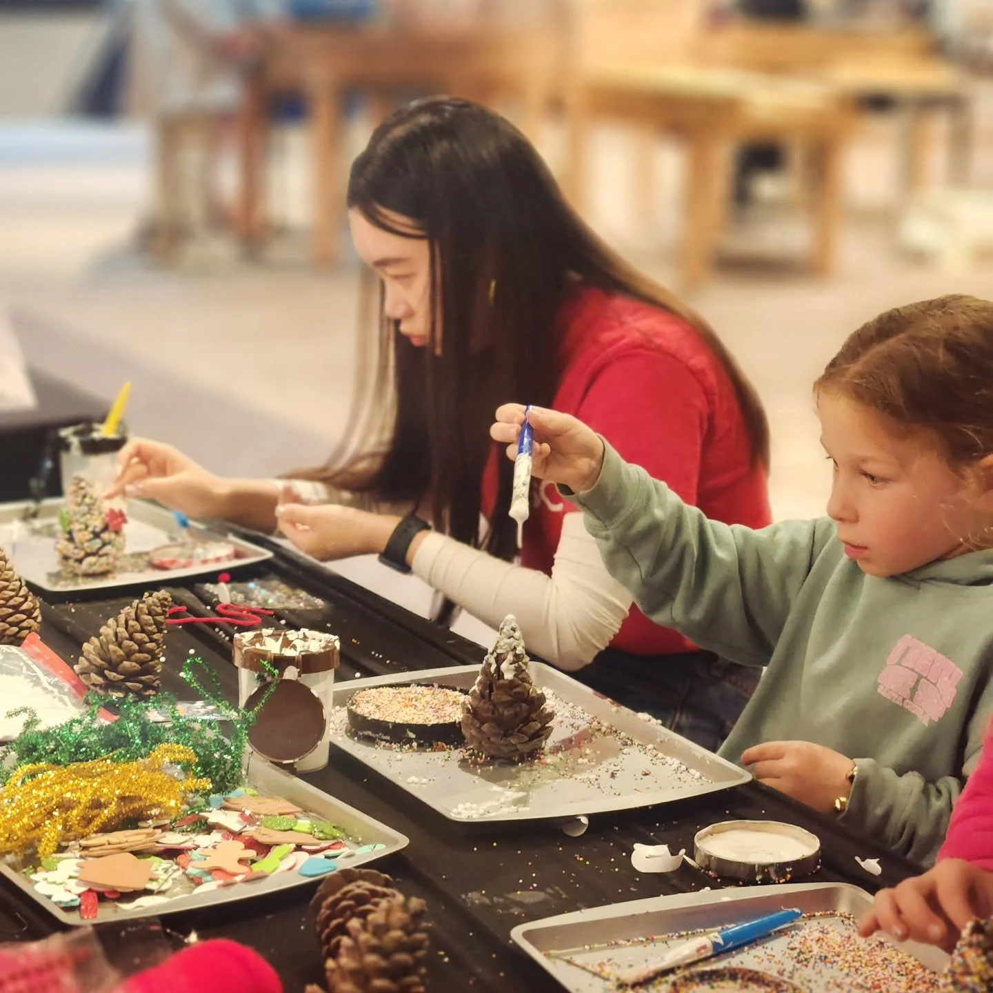 Focused decorating! Did you know we don't use glitter? Instead, we use edible sprinkles or colored decorating sugar.