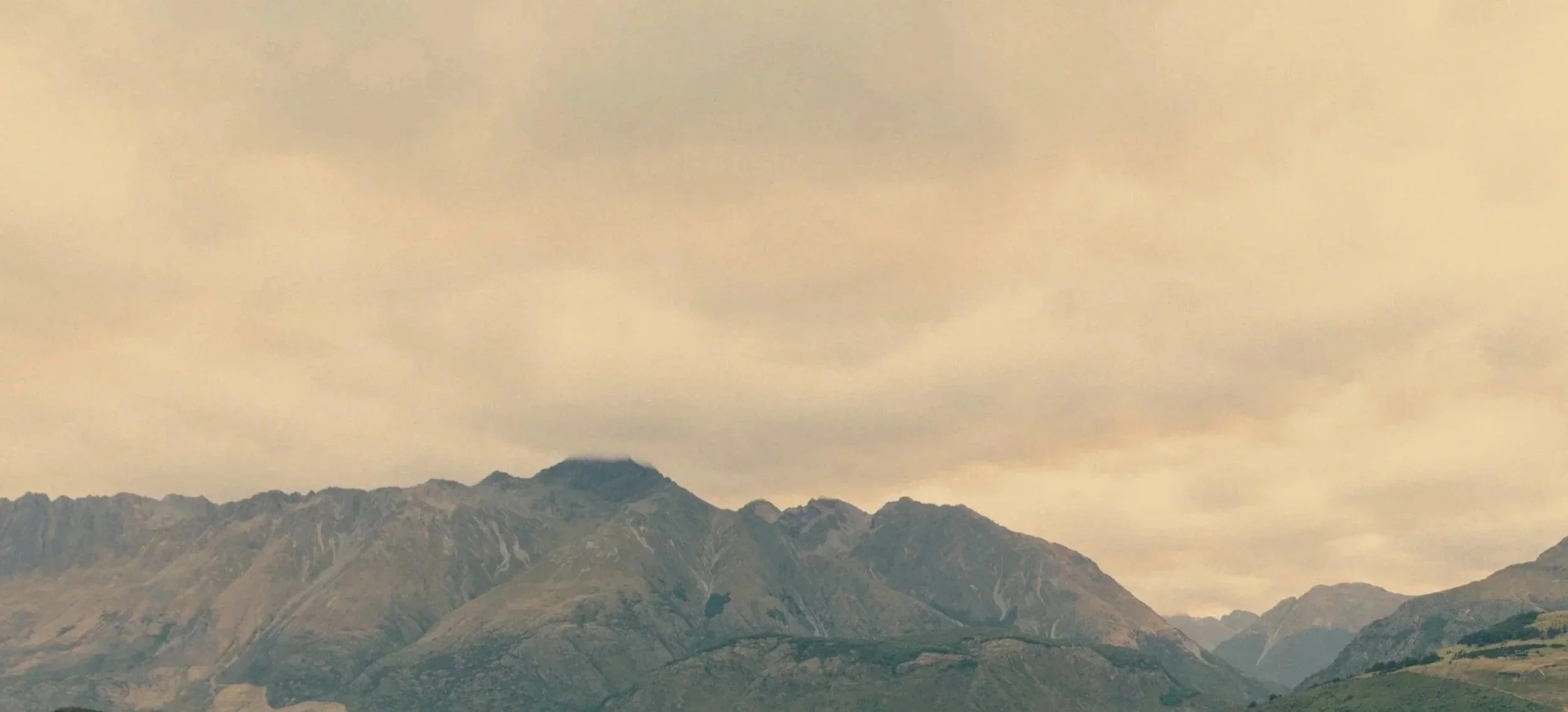 Mountain range under a cloudy sky