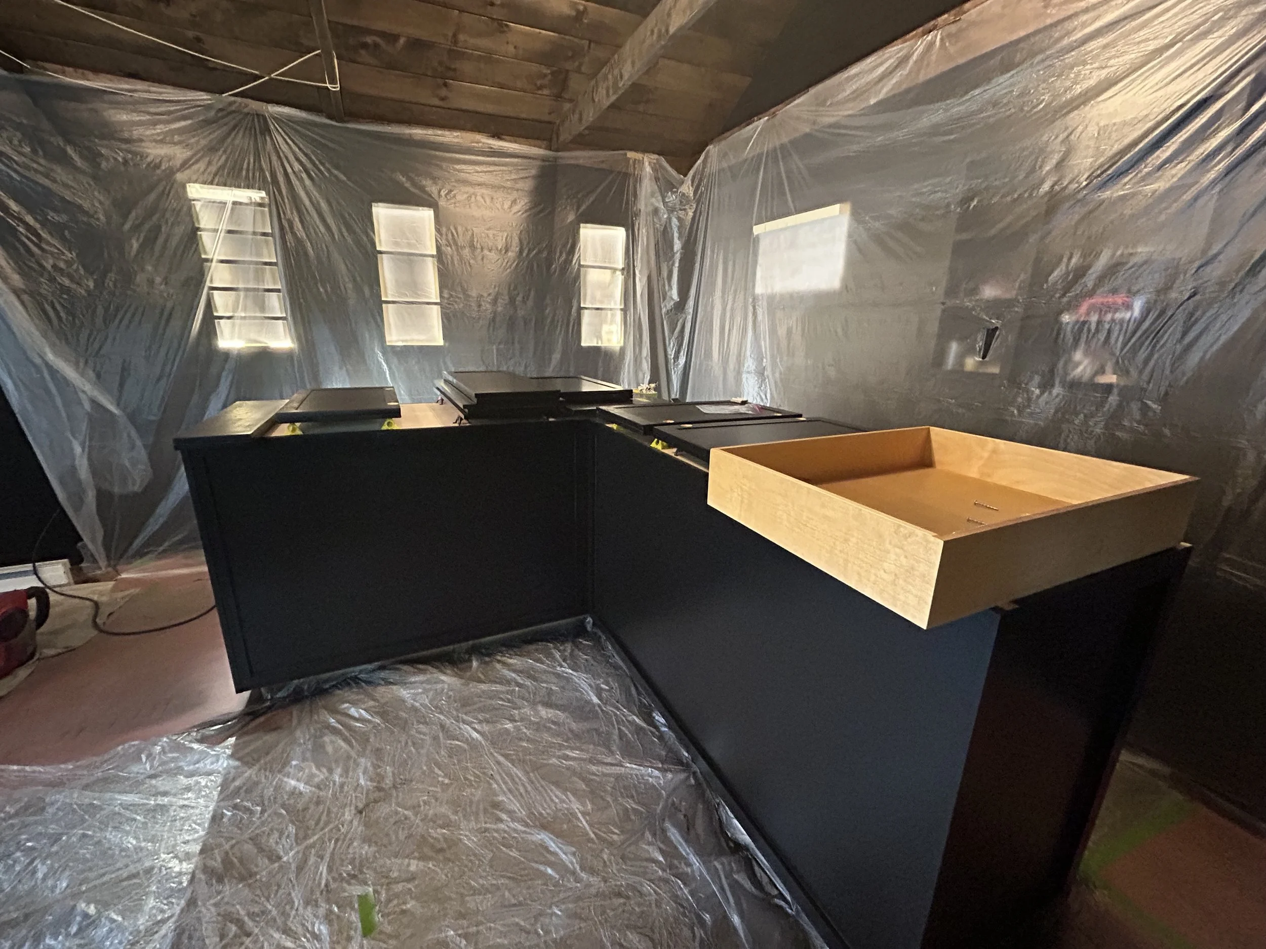 Custom bar cabinetry getting its final sprays