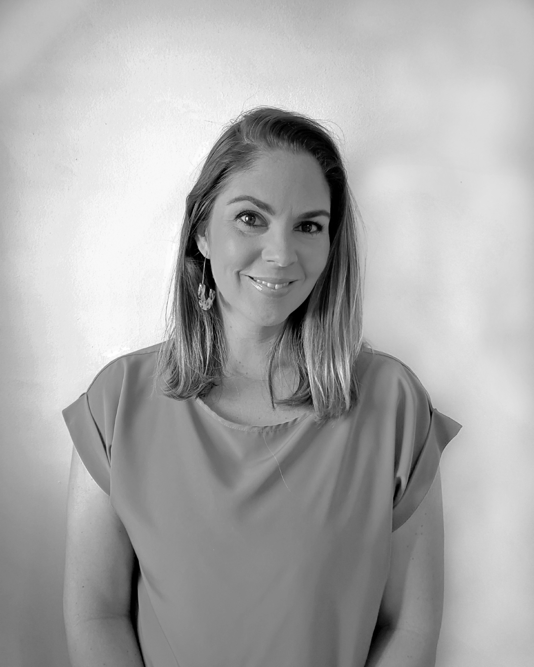 Woman with shoulder-length hair wearing blue top