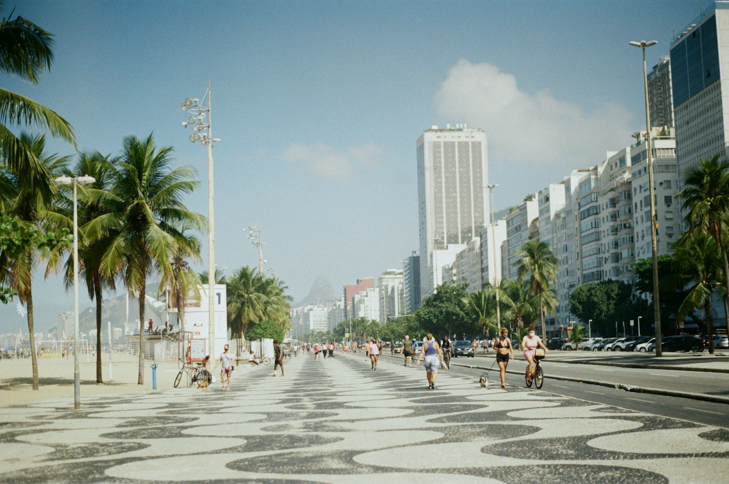 people walking on the beach boardwalk