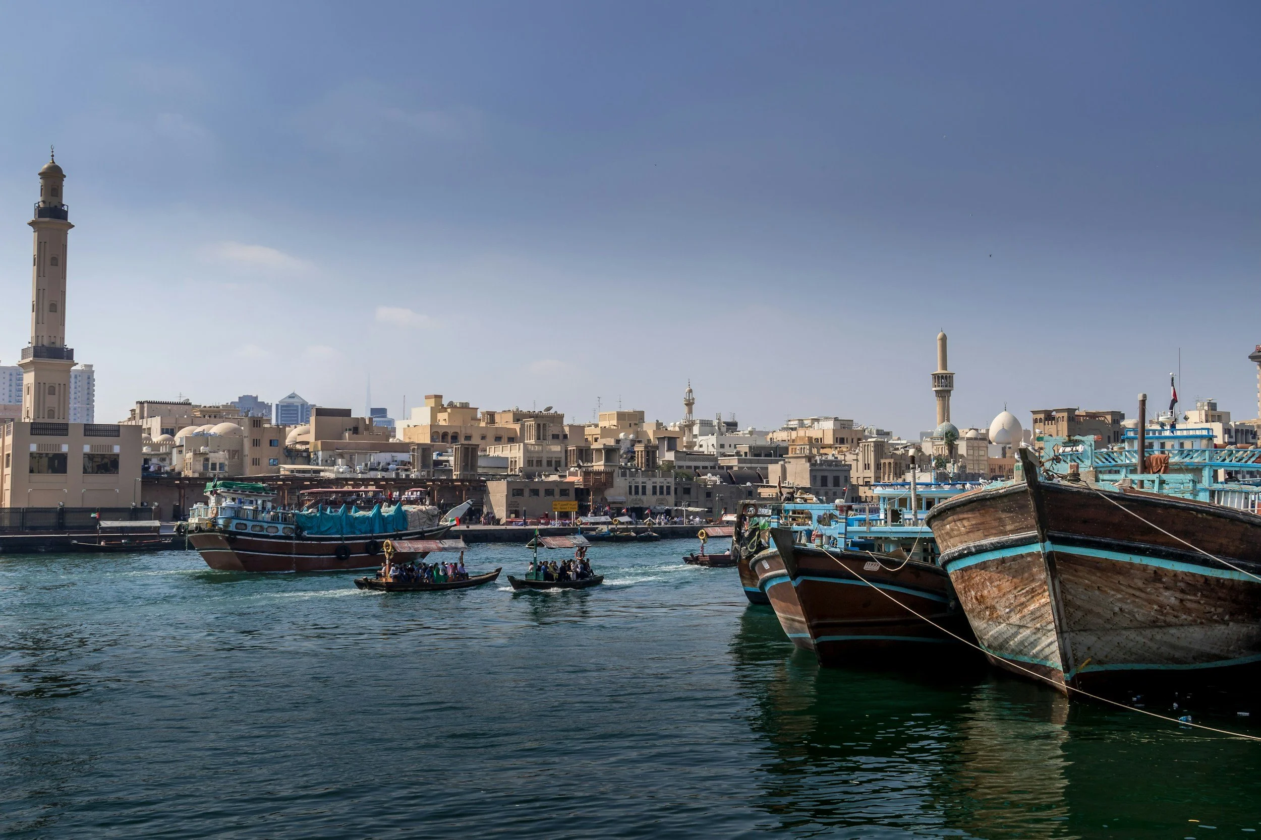boats floating in harbour blue sky