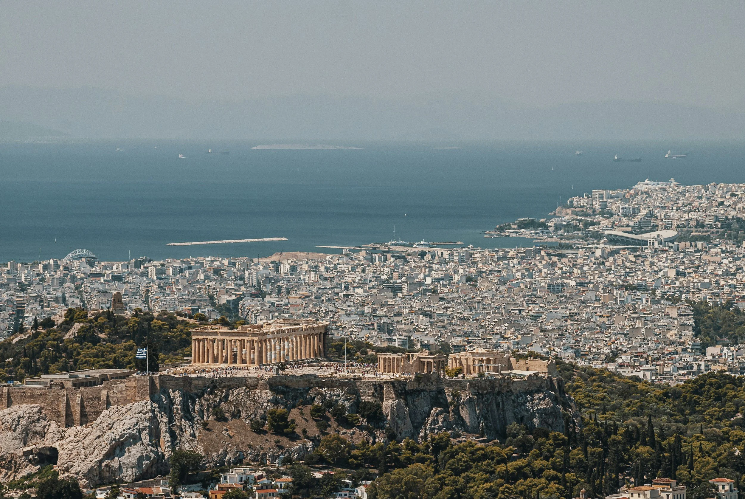 athens and the ocean behind the city shot from above