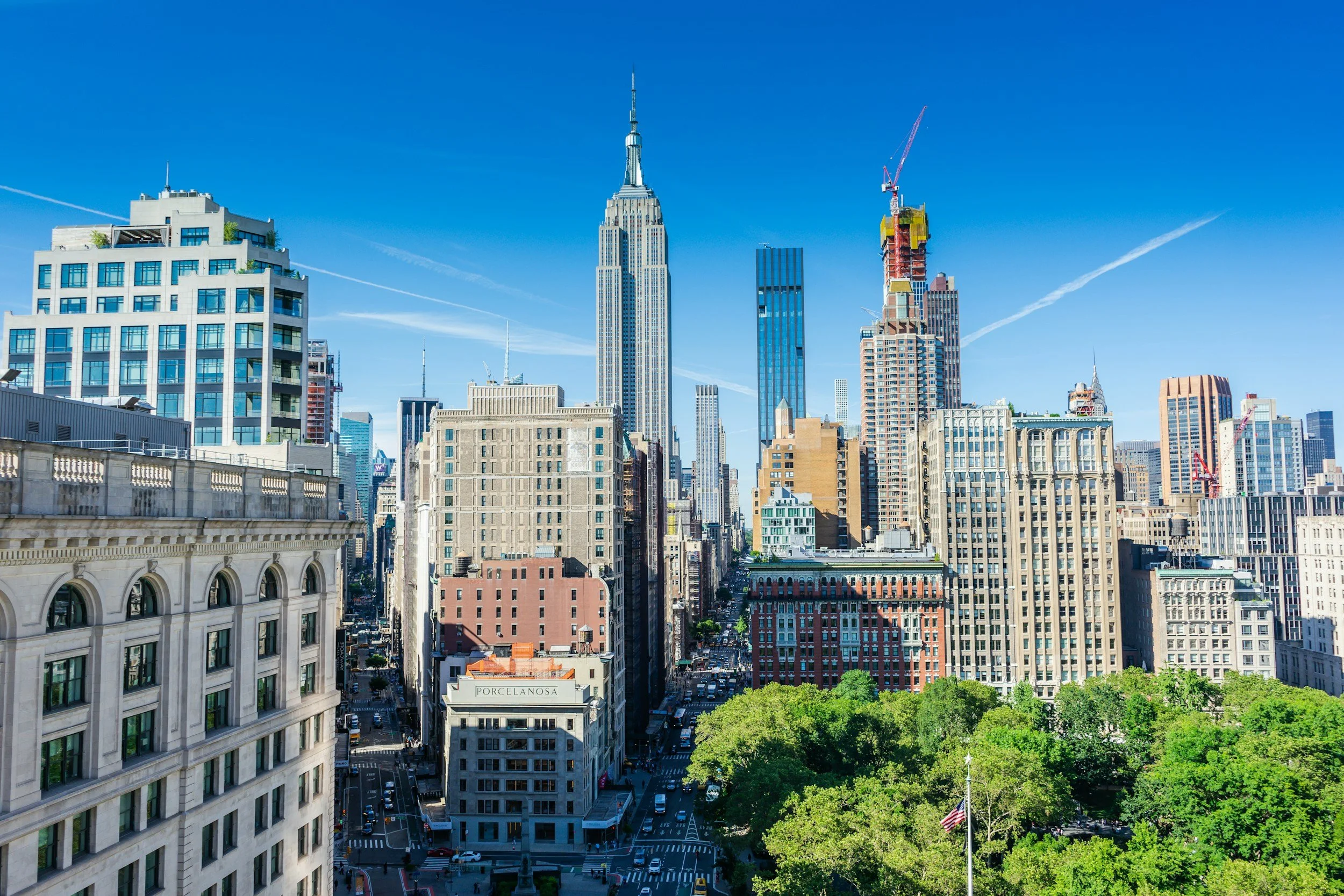 manhattan skyscrapers and edge of park in the sun