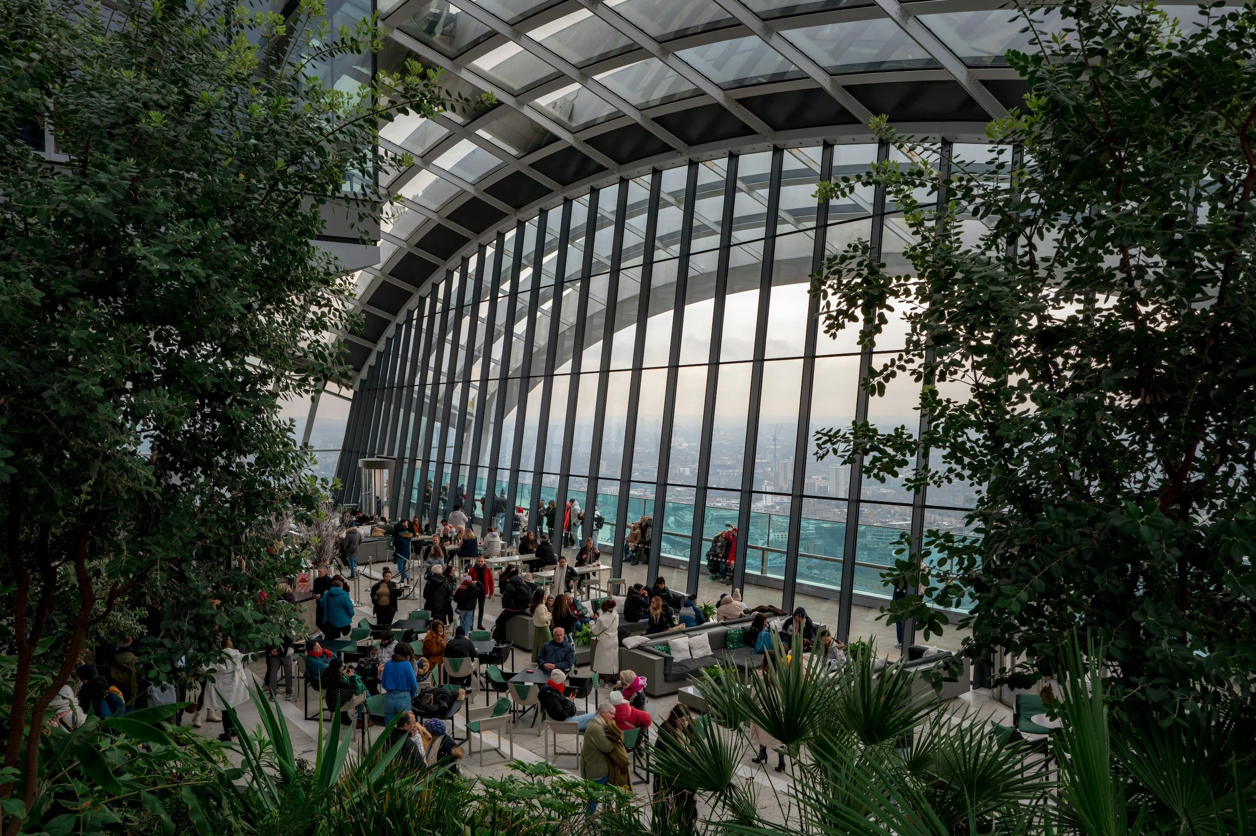 people sat looking out over views of london indoor garden cafe