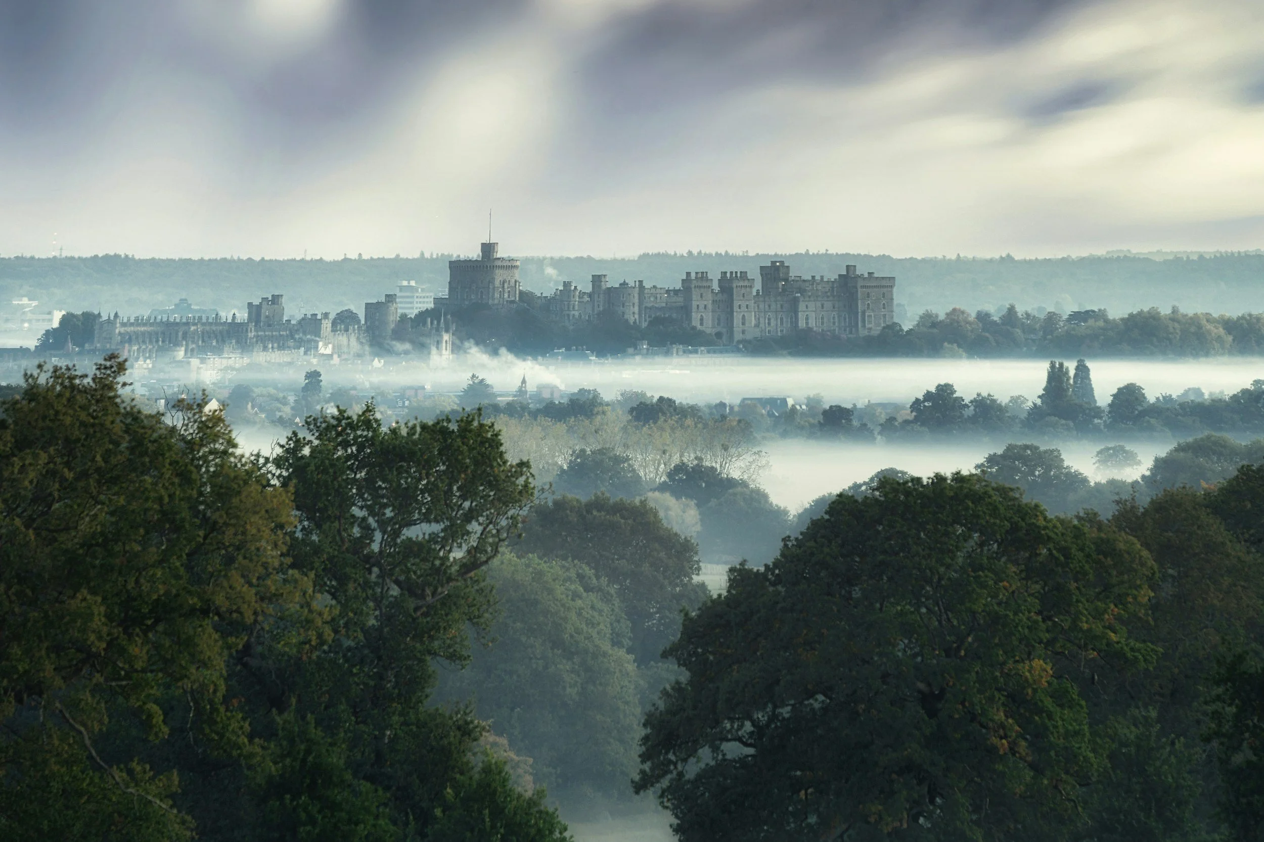 windsor castle rising up from foggy trees