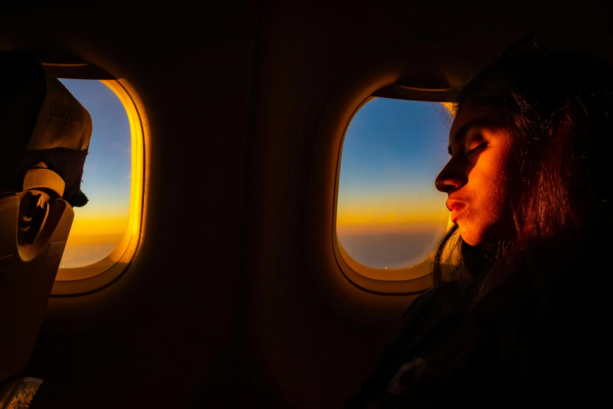 woman sat on flight sunset