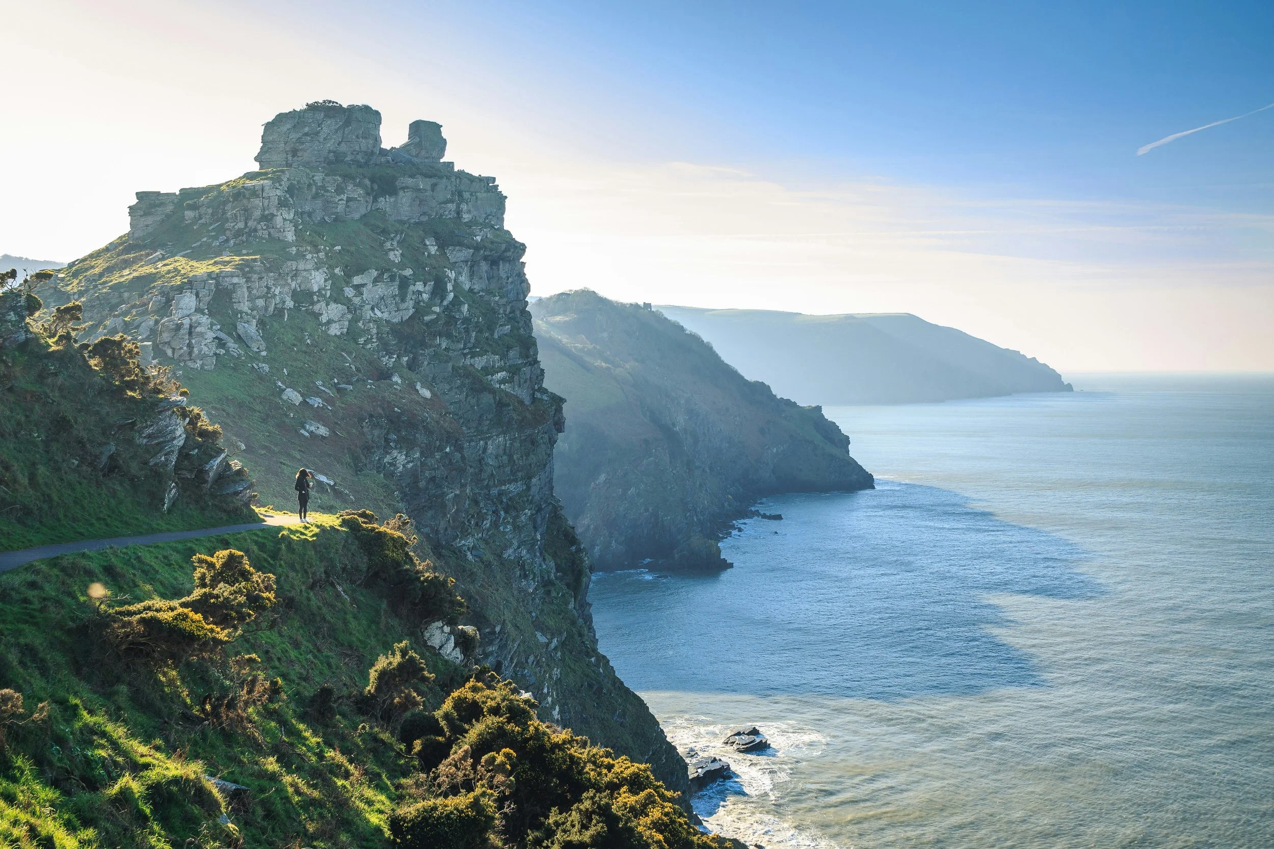 woman on cliffdge coast england