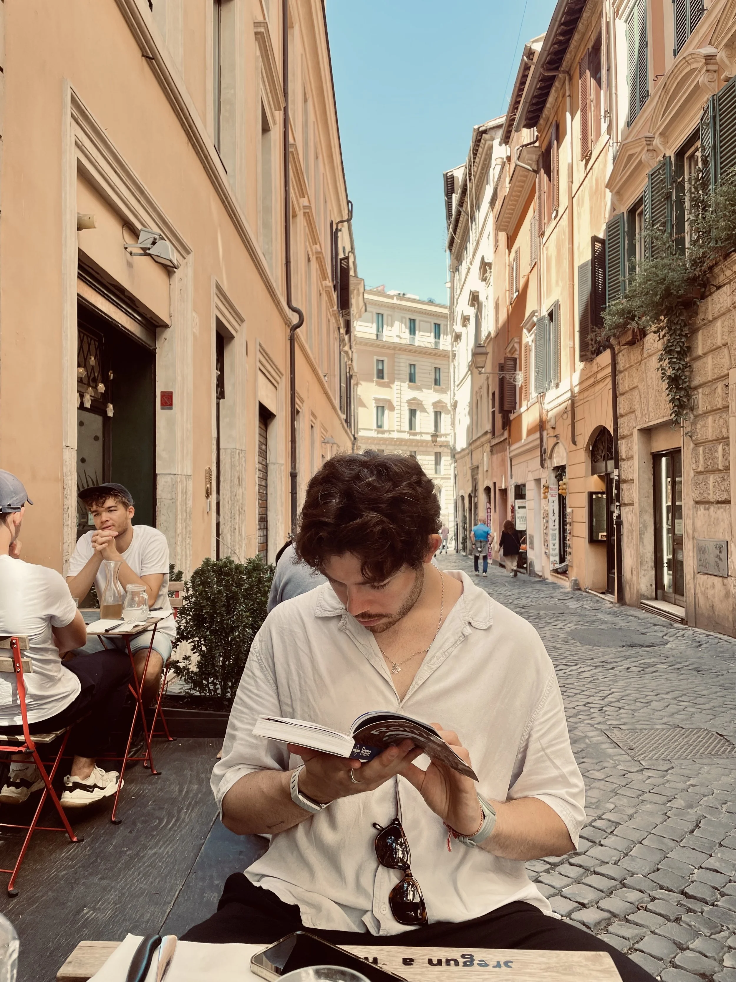 man reading guide  book european city