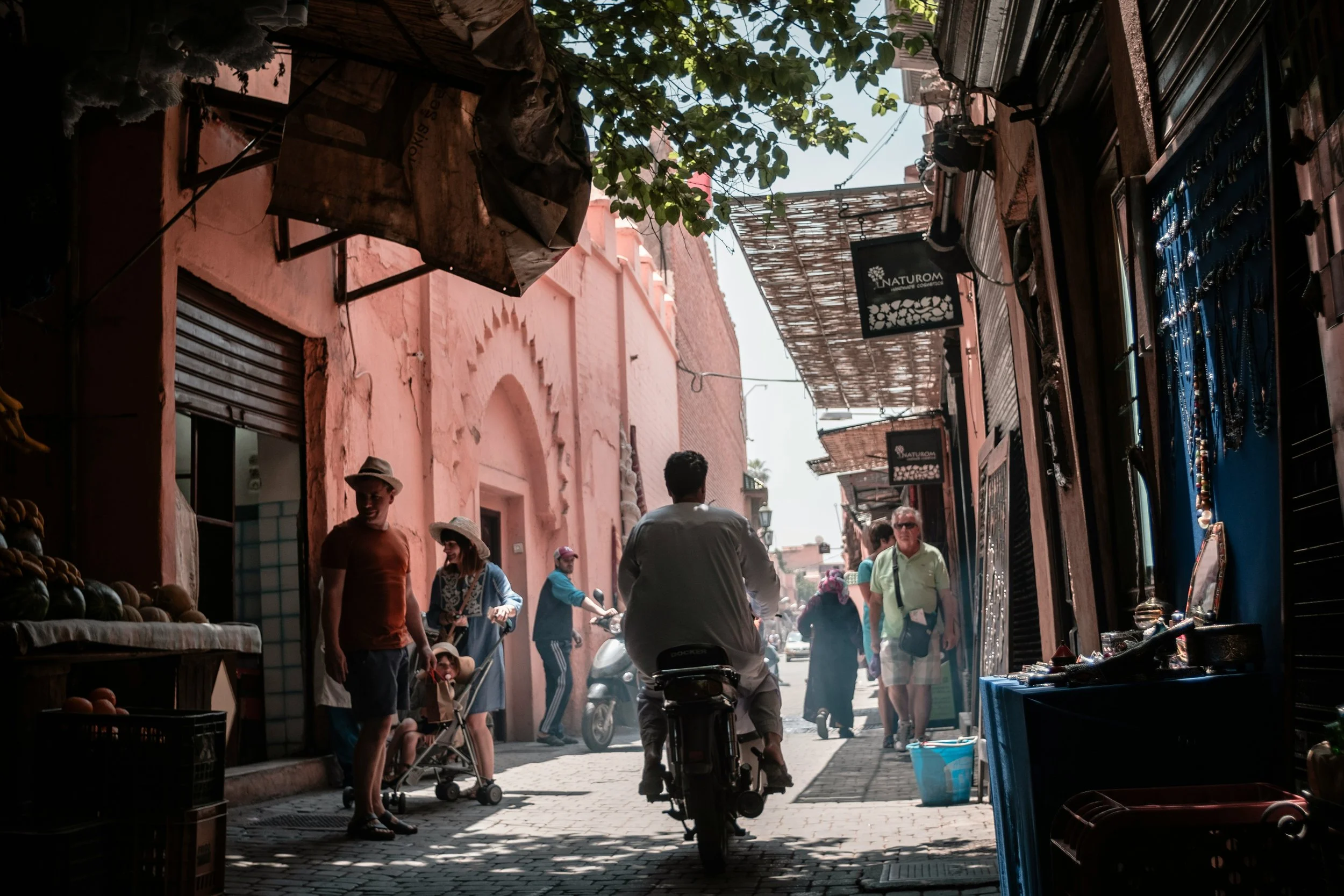 man riding motorcycle through street